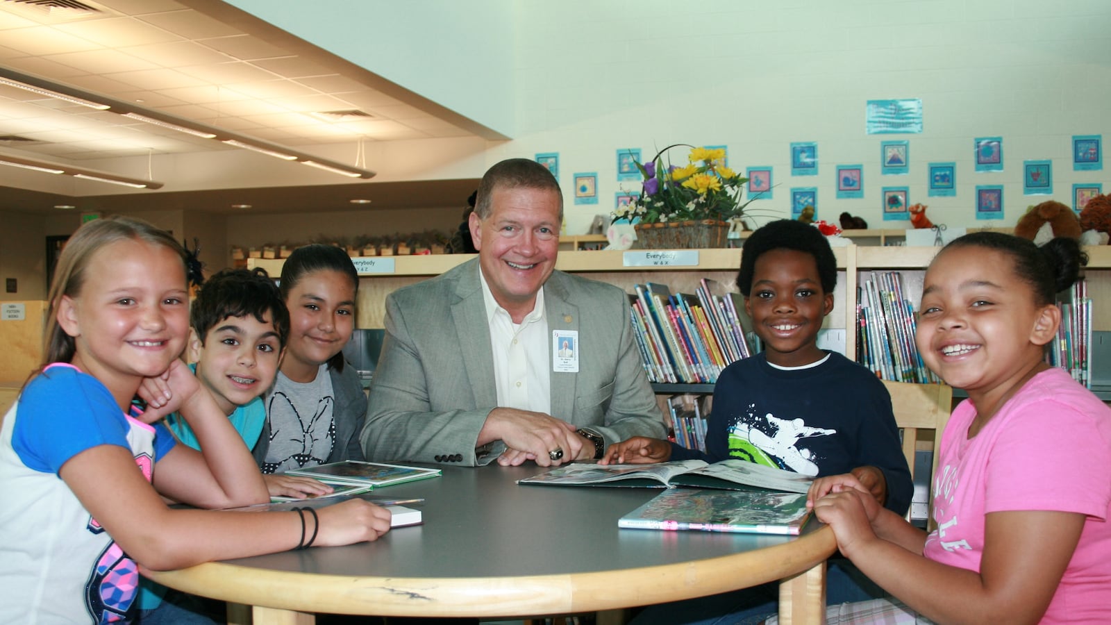Harry Bull, superintendent of Cherry Creek schools, sits with students. (Photo courtesy of Cherry Creek School District)