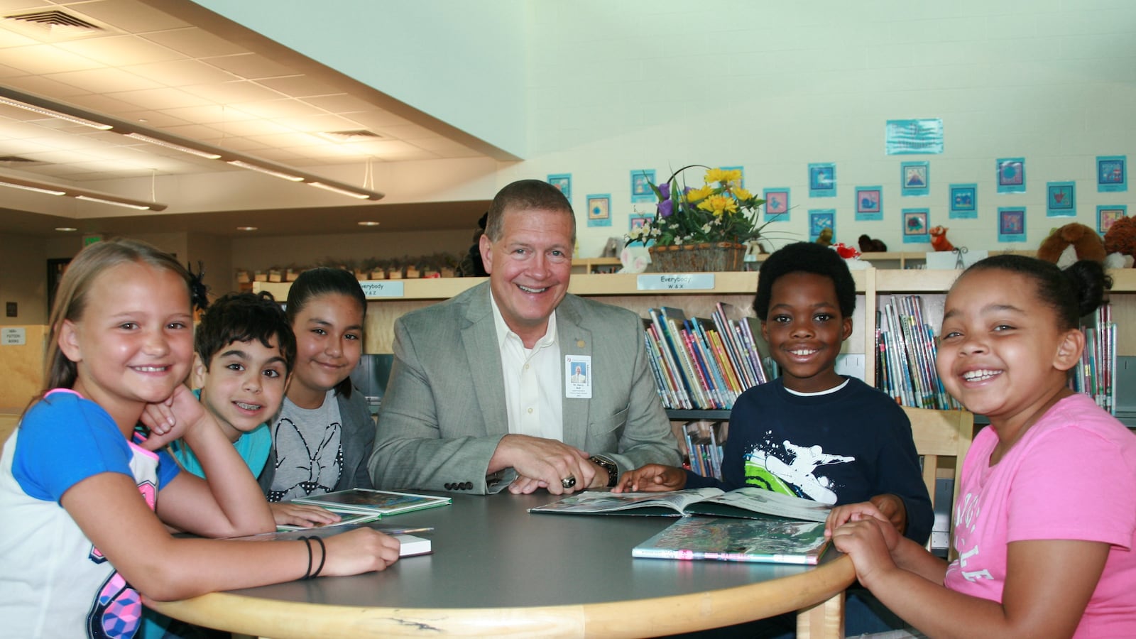 Harry Bull, superintendent of Cherry Creek schools, sits with students. (Photo courtesy of Cherry Creek School District)
