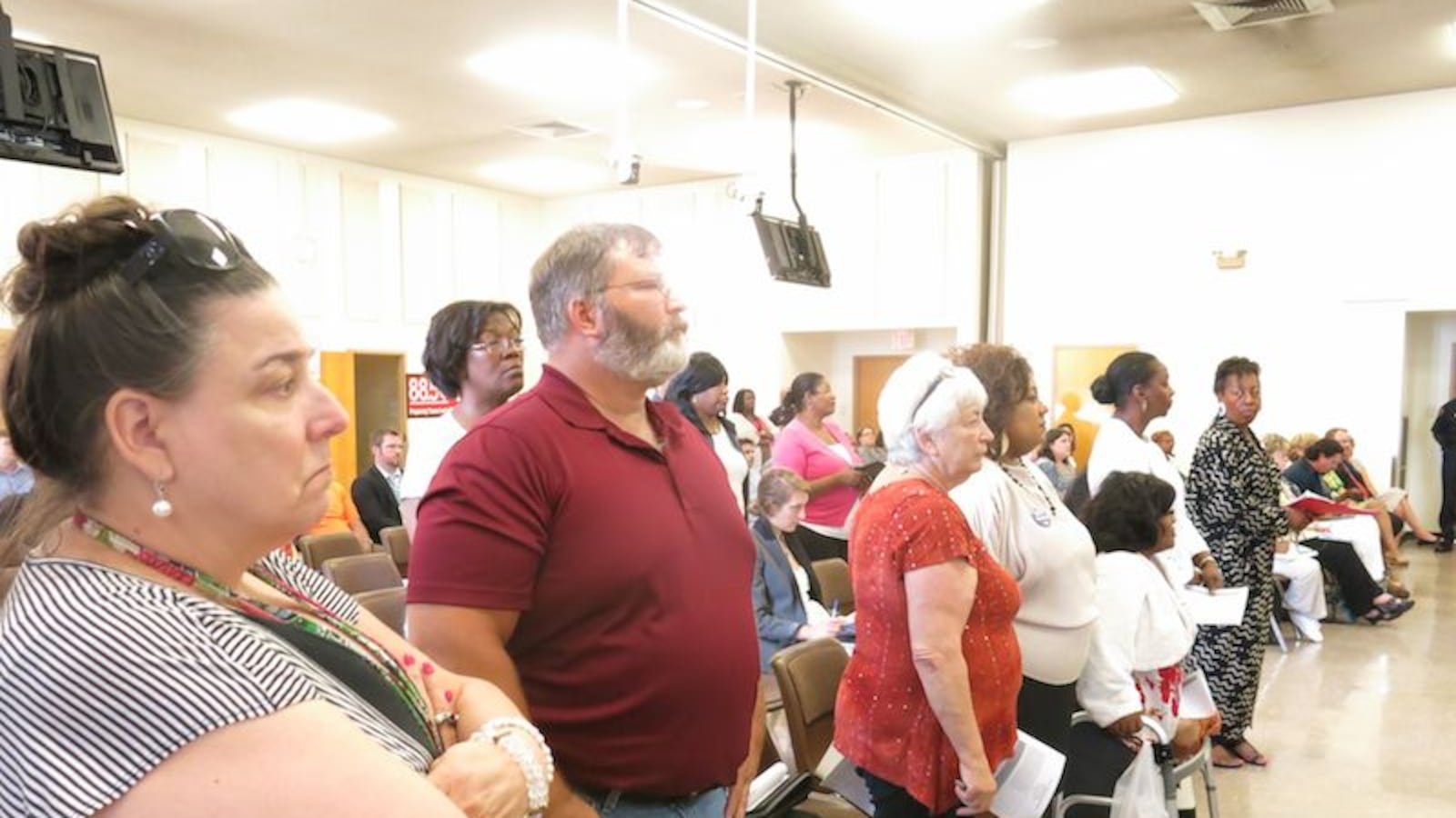 About a dozen Shelby County School teachers stood in solidarity against the district's preferred teacher hiring list and bonus pay plan.