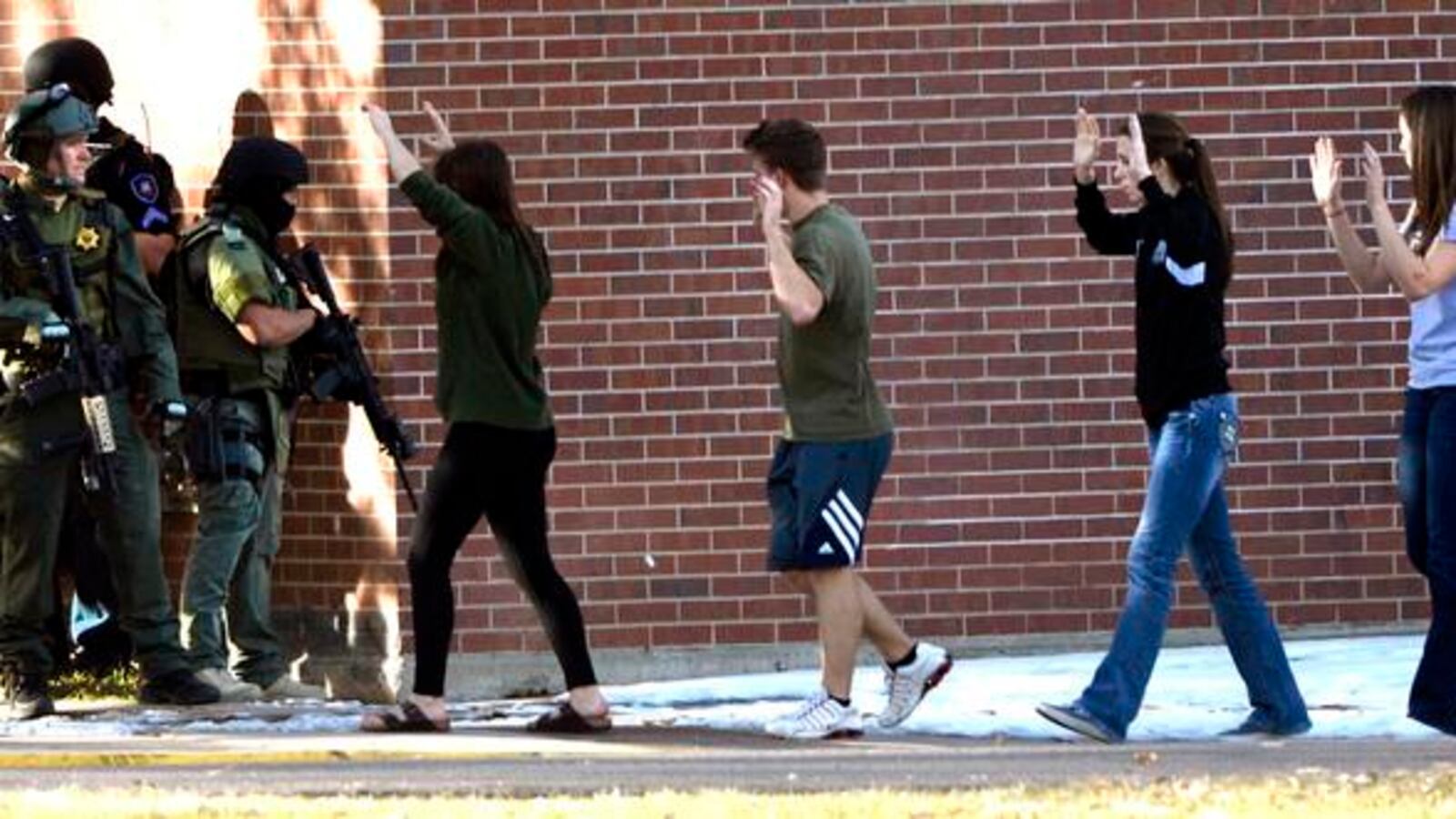 Students are escorted out of Arapahoe High School in Centennial after the 2013 shooting there. (Photo By Craig F. Walker / The Denver Post).