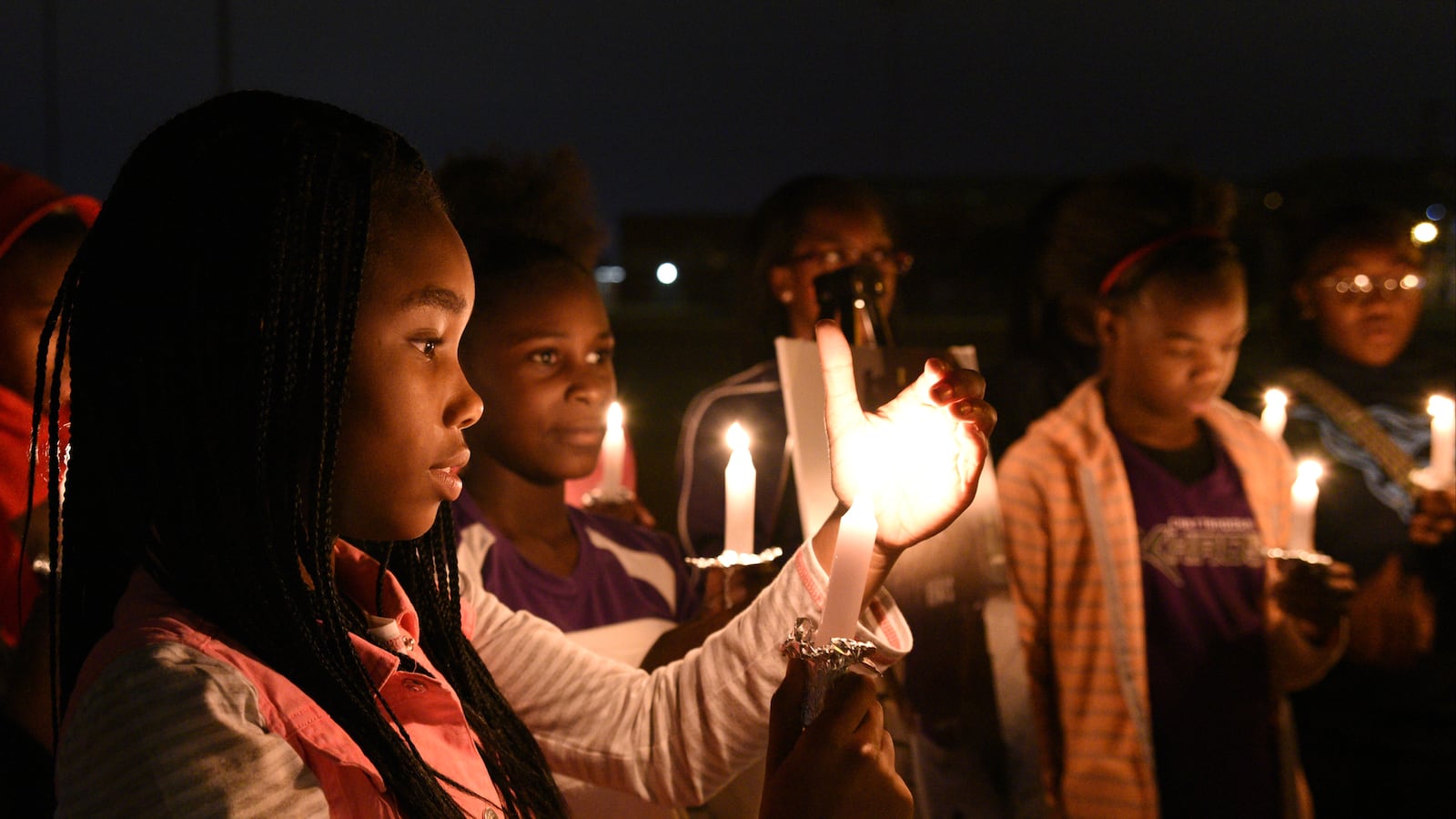 Ma'Liyah Montgomery participates in a candlelight vigil on Nov. 23, 2016, to remember Zoie Nash, one of six elementary school students killed that week in a school bus crash in Chattanooga, Tenn.