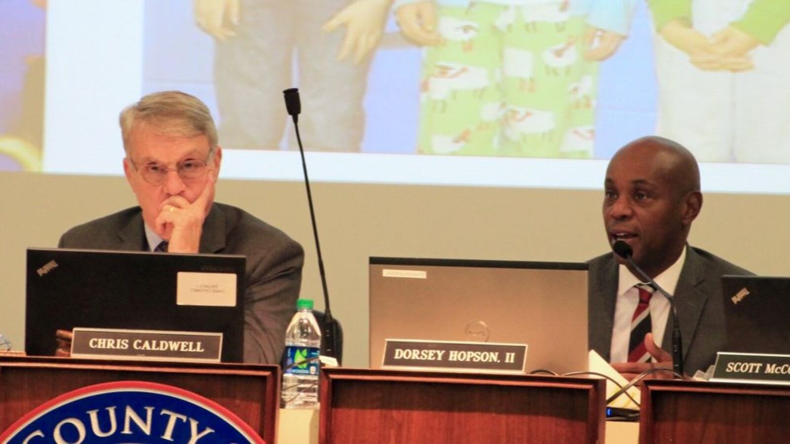 Chairman Chris Caldwell looks on while Superintendent Dorsey Hopson presents his plan.