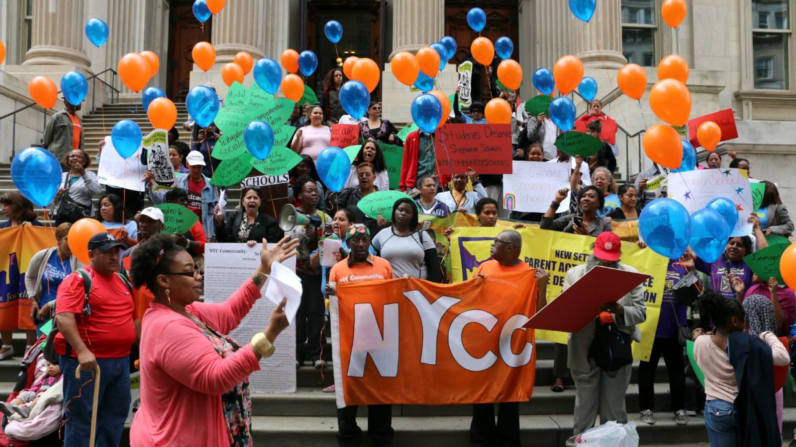 Community school proponents rallied in front of education department headquarters Tuesday.