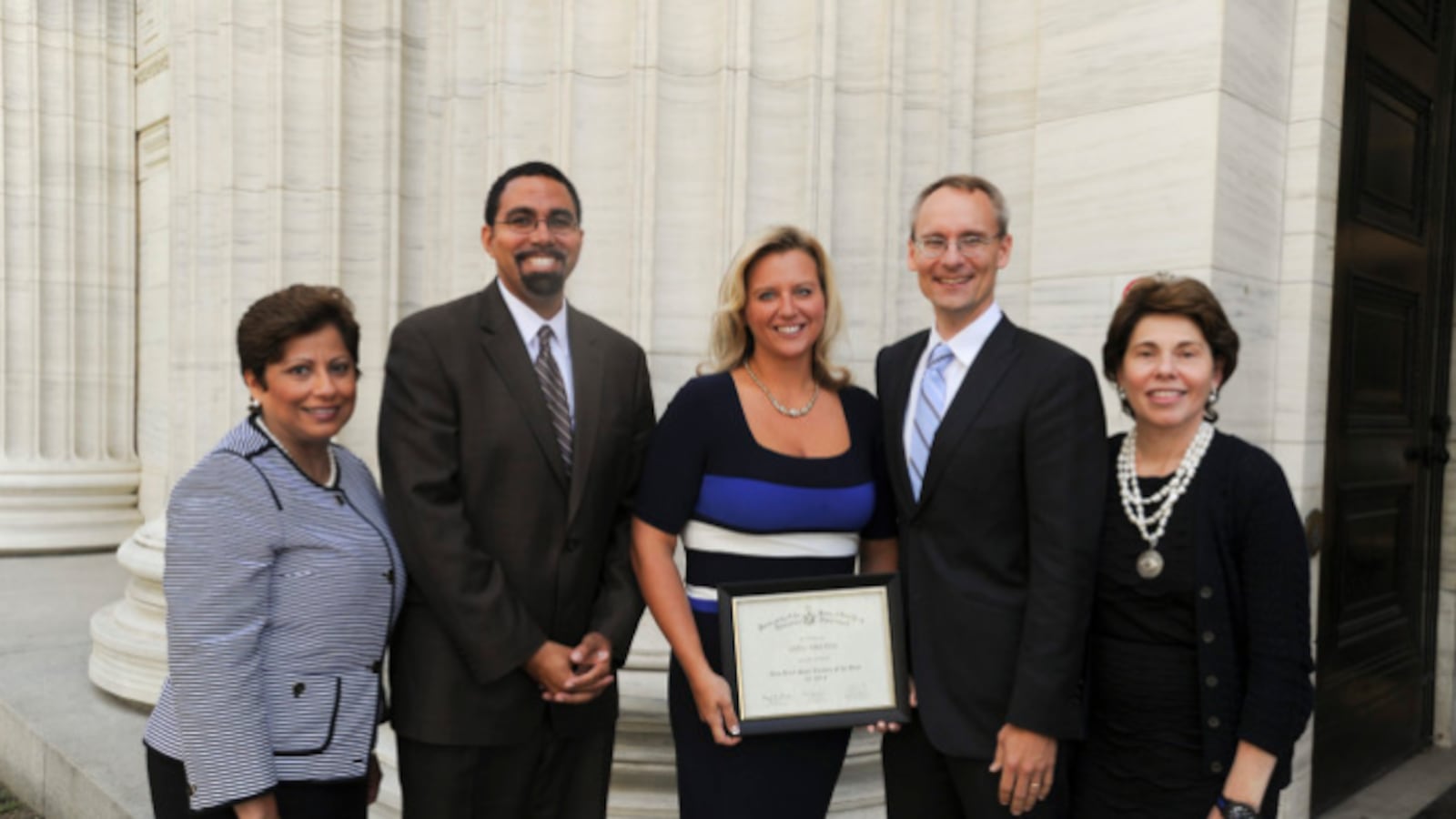 Ashli Skura Dreher, middle, is recognized in 2013 as New York State's Teacher of the Year. She is defending tenure in a lawsuit challenging the state's job protection laws.