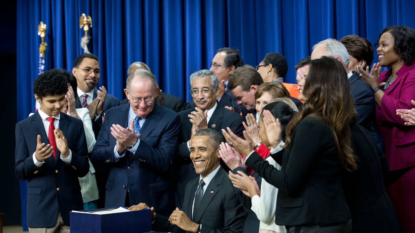 President Barack Obama signs the Every Student Succeeds Act in December 2015, surrounded by U.S. Sen. Lamar Alexander of Tennessee and other champions and supporters of the new law.