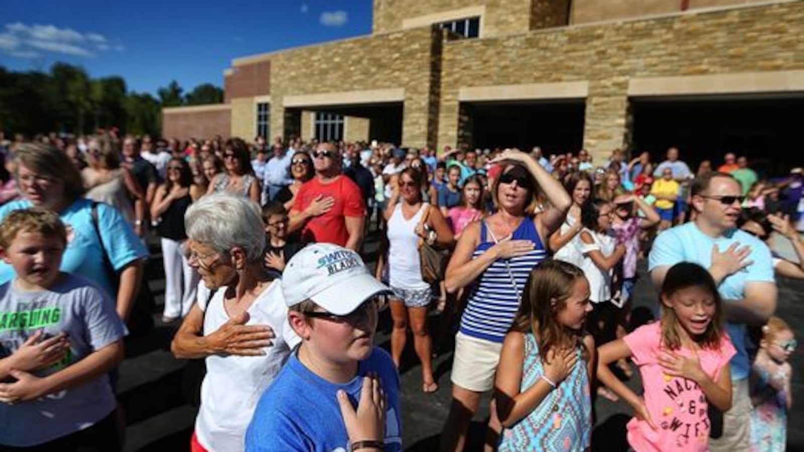 Students, teachers and parents gather for the Pledge of Allegiance outside Lakeland Middle Preparatory School during a dedication ceremony for the new school.