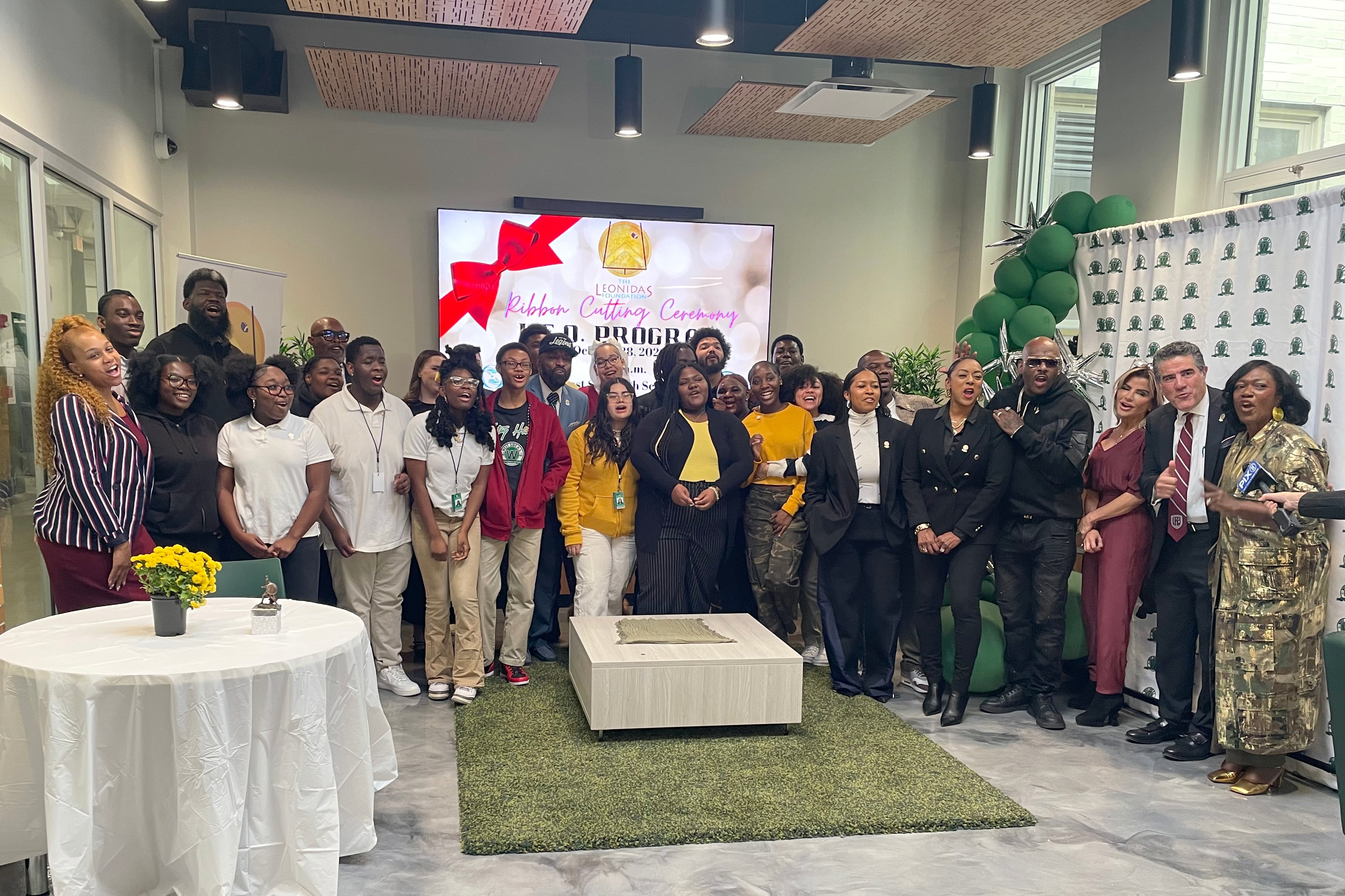 A group of people in business clothes stand together for a portrait.