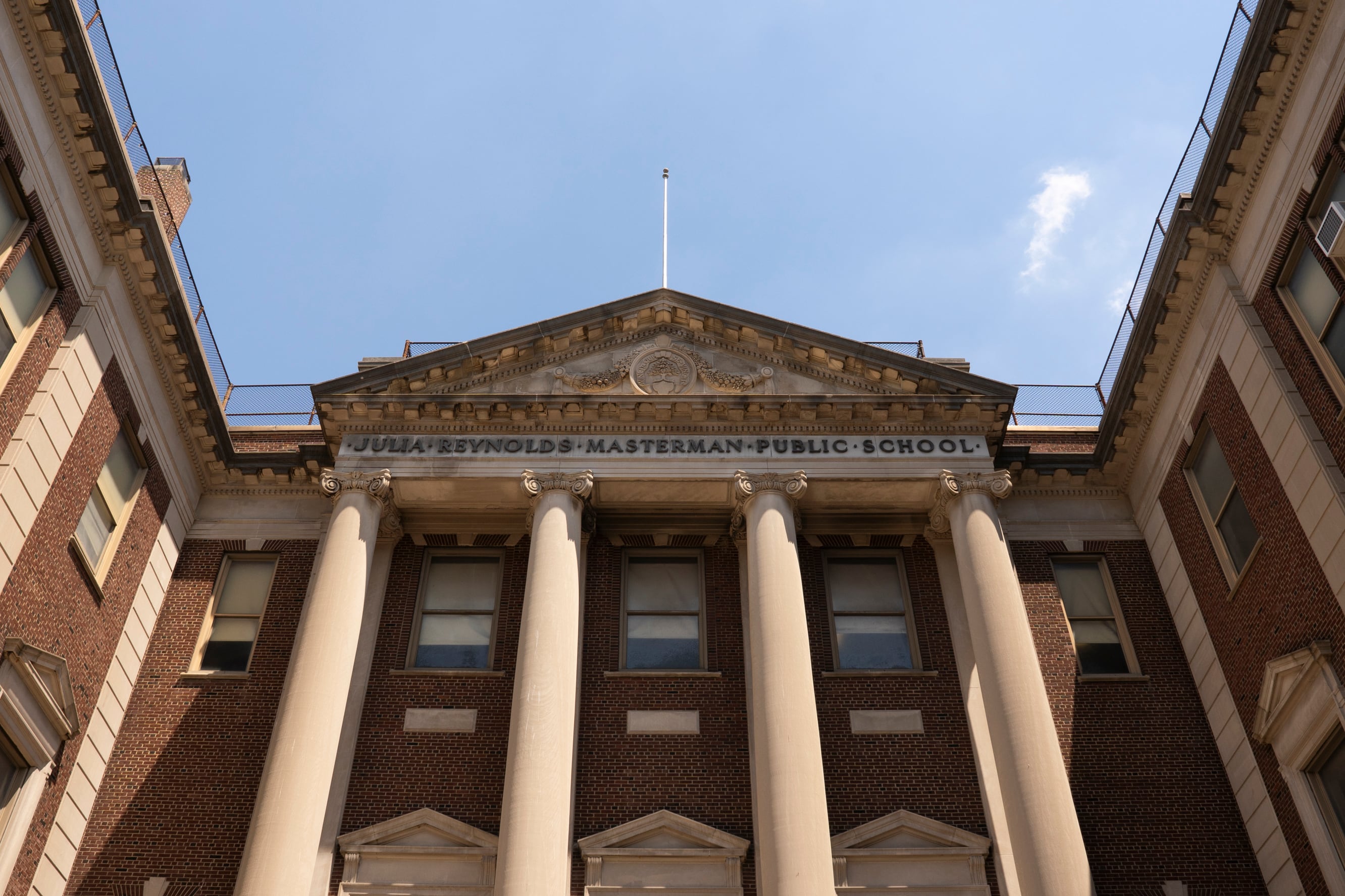 A photograph of Masterman Public School, a brownstone building with white pillars.
