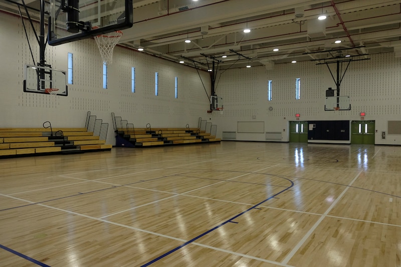 A photograph of a large empty school gym.