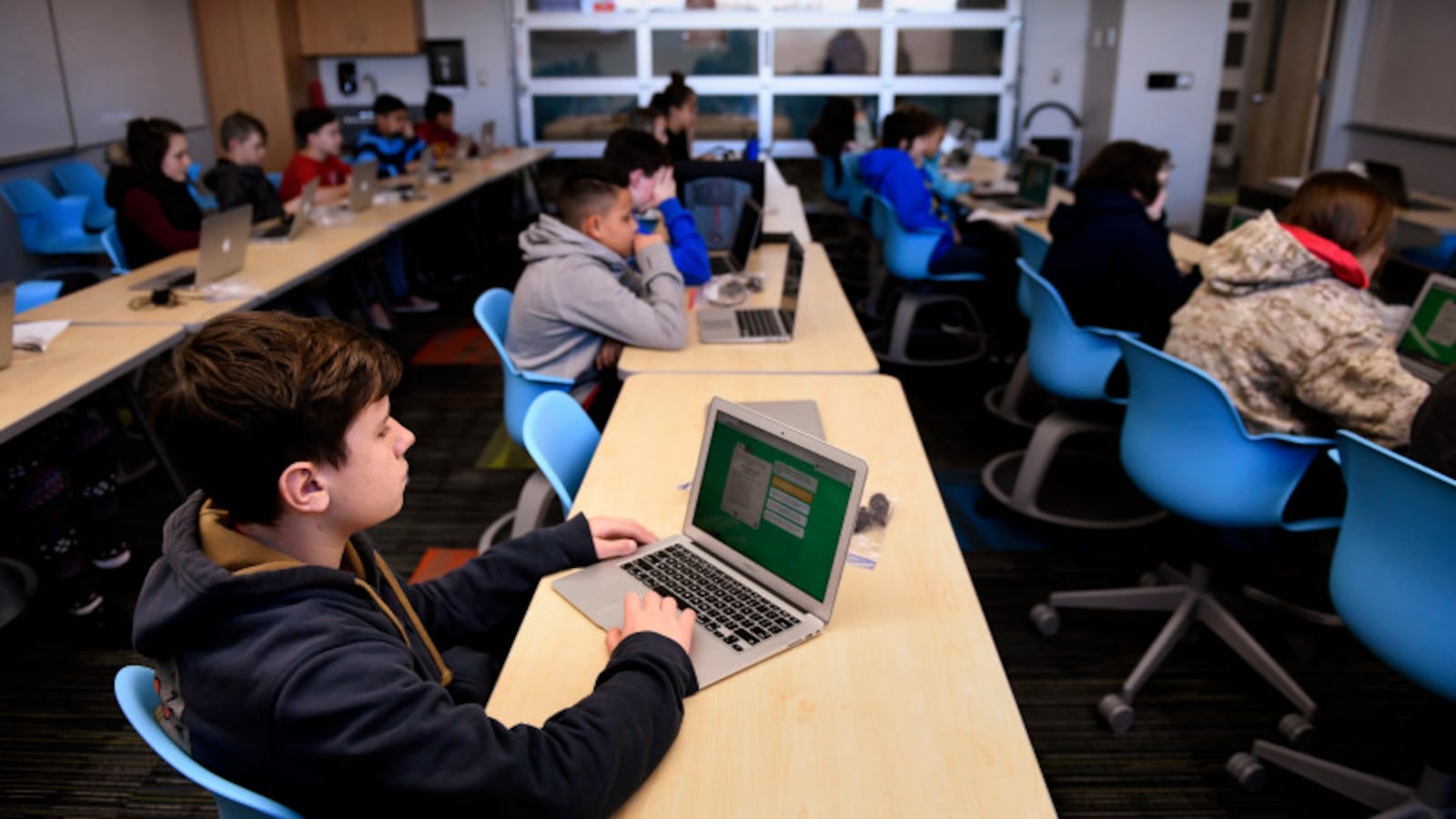Seventh-grader Jack White works on a laptop computer at Columbine Middle School in Montrose, Colorado in December 2018.