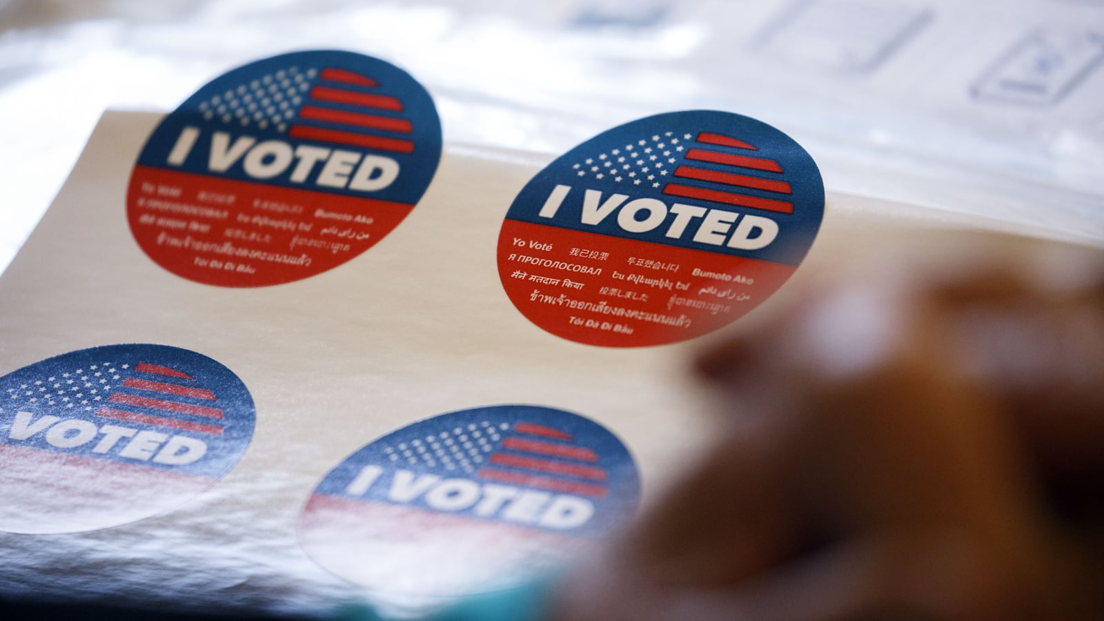 Close up shot of red, white, and blue stickers that read “I VOTED.”