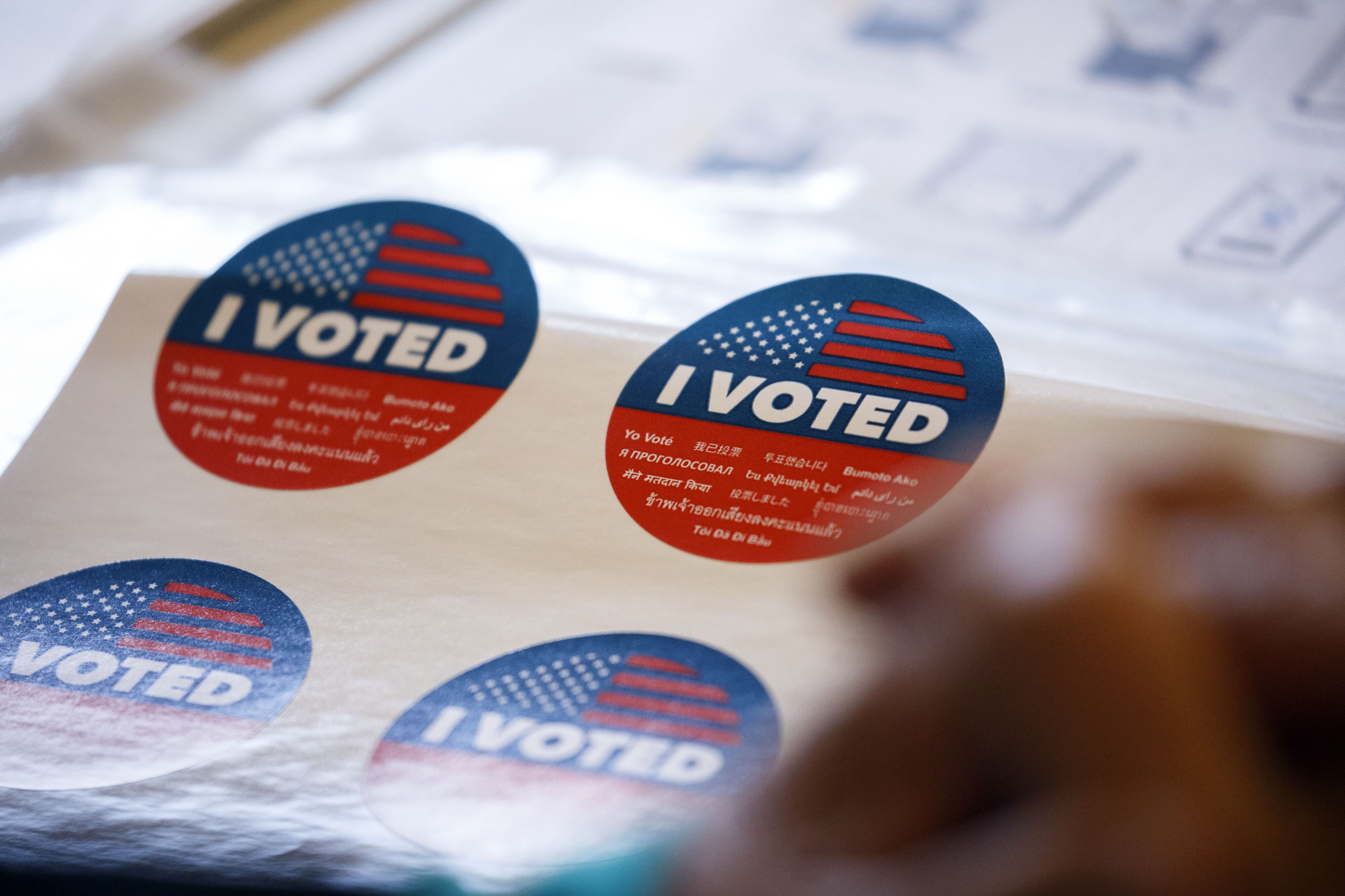 Close up shot of red, white, and blue stickers that read “I VOTED.”
