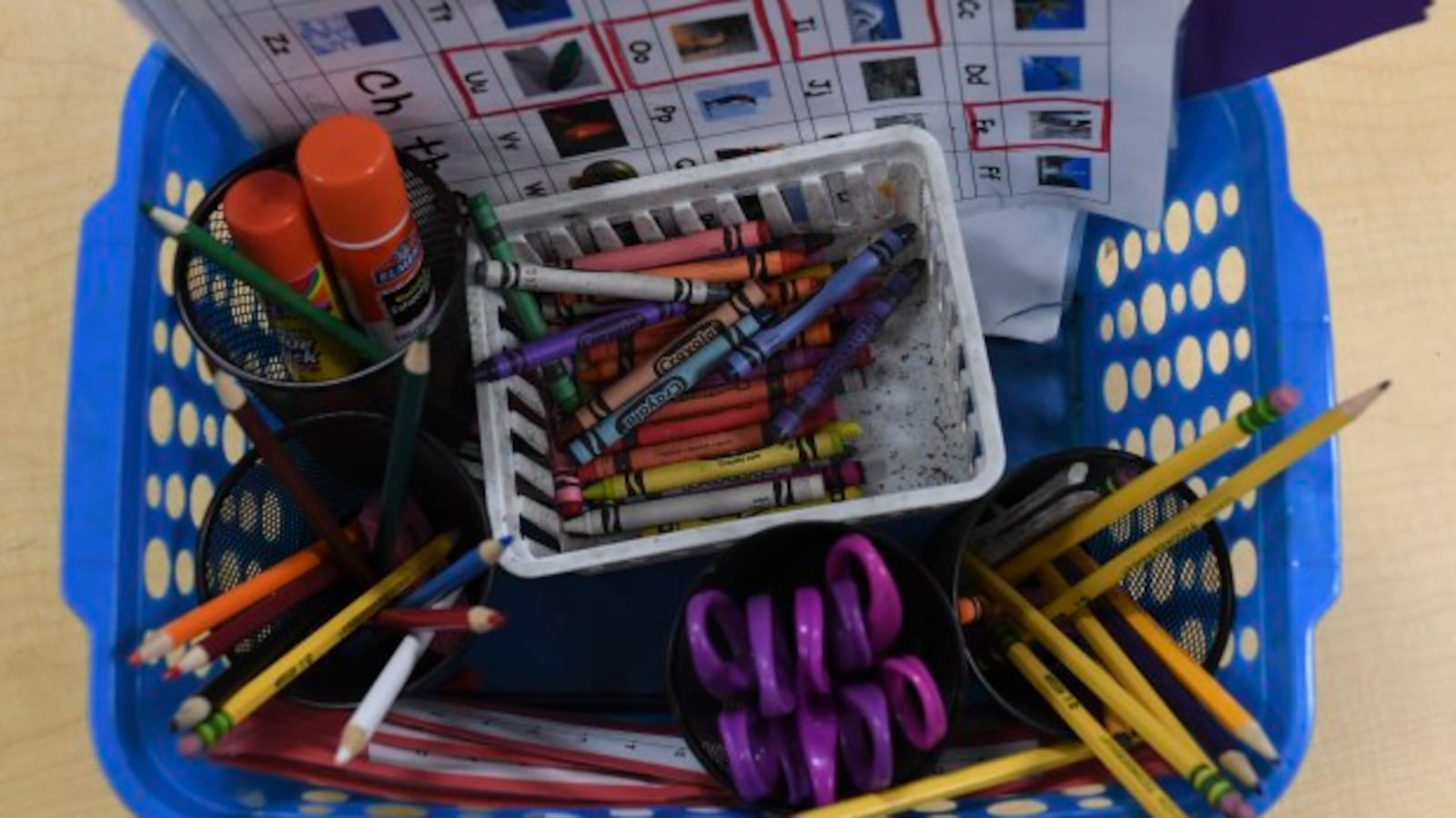 A basket of classroom supplies in a kindergarten class.