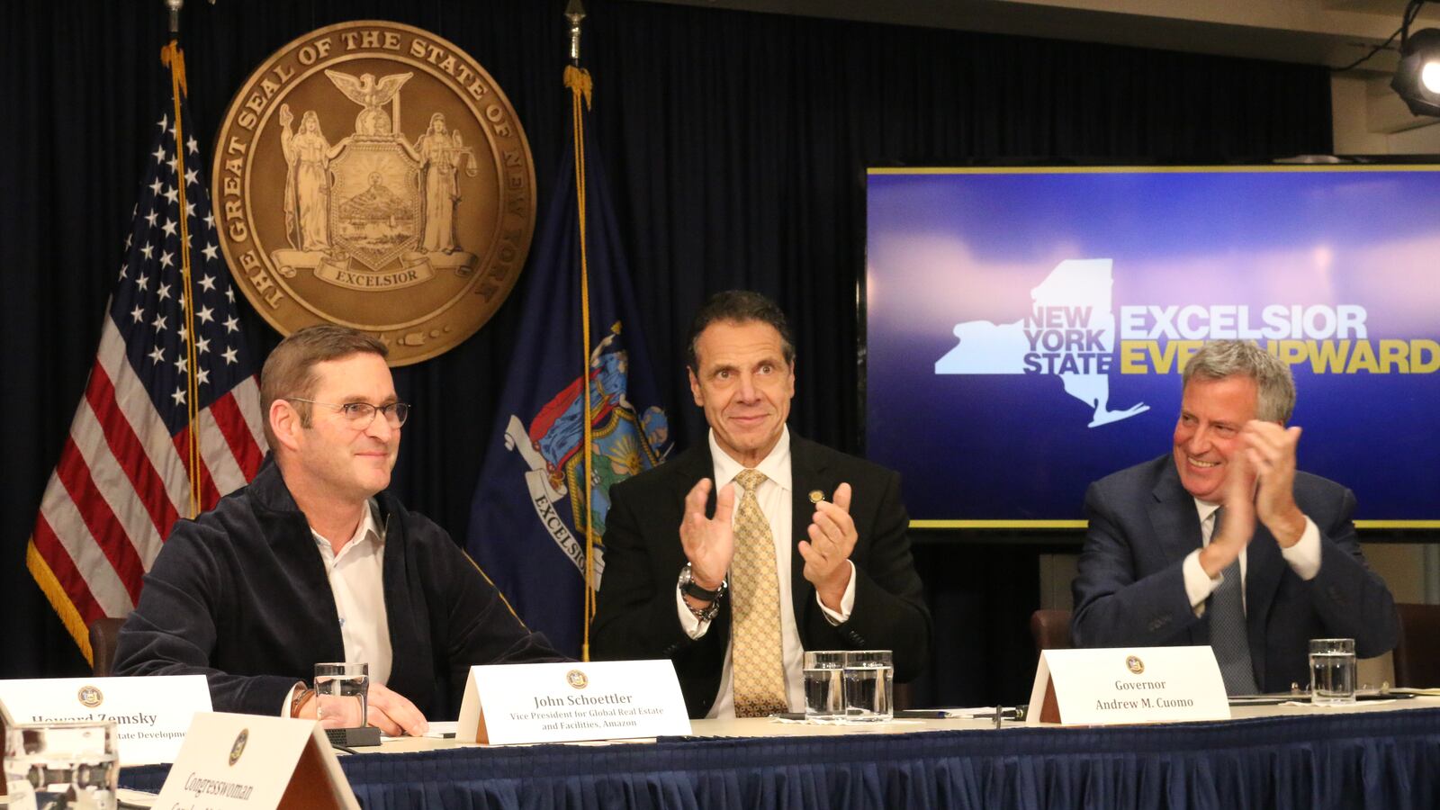 John Schoettler, Amazon's vice president of global real estate and facilities, (left) sits with Gov. Andrew Cuomo and Mayor Bill de Blasio at a press conference about Amazon's announcement to open part of its new headquarters in Long Island City.