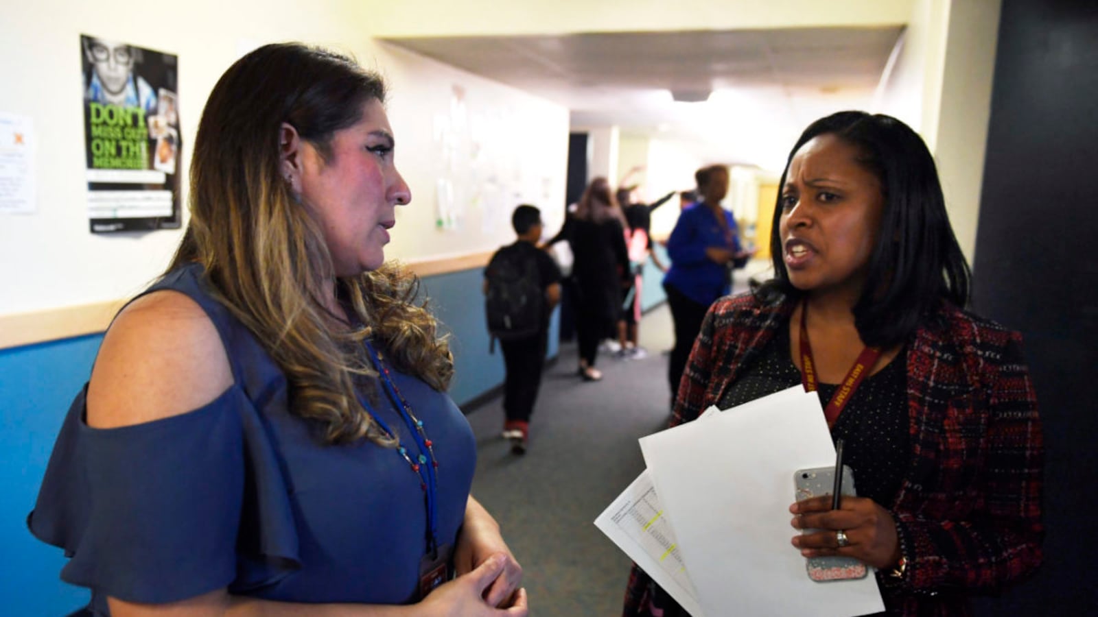 A teacher talks about one of her students with principal Biaze Houston, right, at East Middle School in Aurora. (Photo by Joe Amon/The Denver Post)