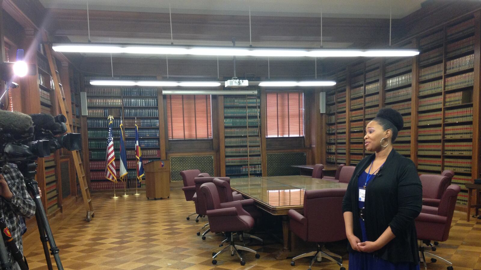 Santoya Baxter, visiting from Georgia, is in Denver this weekend considering becoming a teacher in DPS. Here, she talks to television news cameras after she and other teaching candidates met with Mayor Michael Hancock. (Photo by Melanie Asmar)