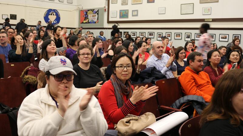 Parents in January 2020 applaud a speaker during a contentious meeting to discuss middle school integration plans for District 28 in Queens. Fights how to make New York City schools more representative of student demographics have filtered down to the races to elect Community Education Council members.