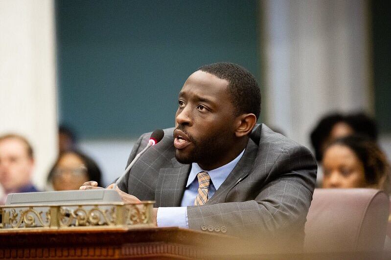A man in a suit sitting at a table.
