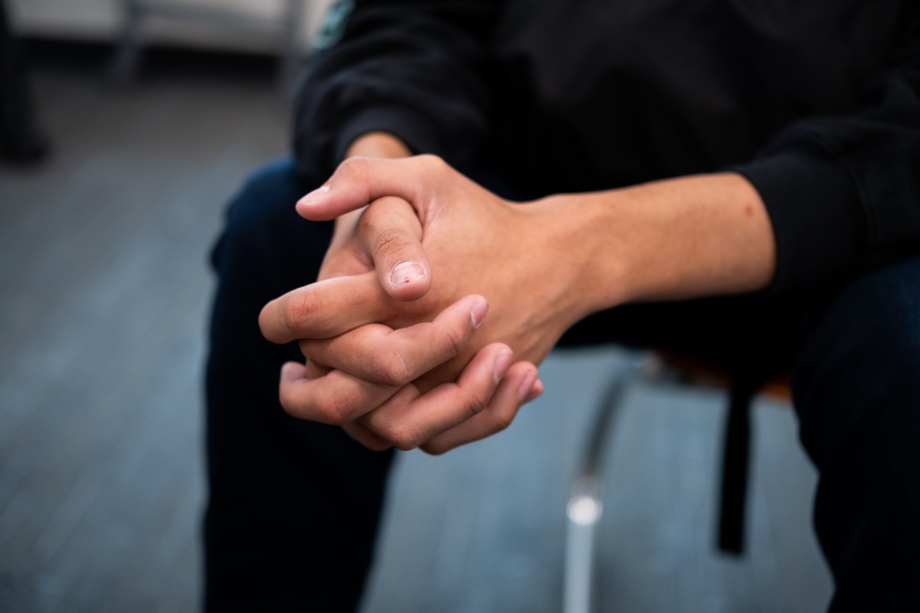 Gabriel Watkins clasps his hands as he watches Philonise Floyd react to the conviction of former Minneapolis police officer Derek Chauvin for the murder of his brother, George Floyd, during a discussion between Northfield High School student council officers and members in Denver, Colorado, on Wednesday, April 21, 2021.