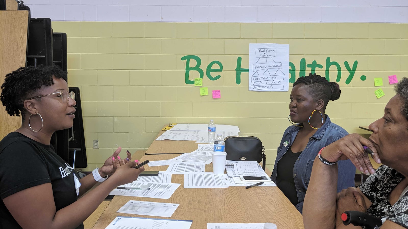 Community organizer Chanita Jones-Howard, a teacher at South Shore International College Preparatory High School, discusses solutions to enrollment and facility problems at South Side schools with school advocates.