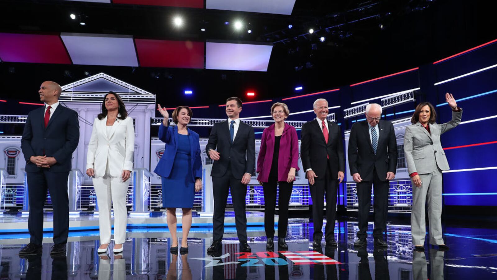 ATLANTA, GEORGIA - NOVEMBER 20: Democratic presidential candidates (L-R) Sen. Cory Booker (D-NJ), Rep. Tulsi Gabbard (D-HI), Sen. Amy Klobuchar (D-MN), South Bend, Indiana Mayor Pete Buttigieg, Sen. Elizabeth Warren (D-MA), former Vice President Joe Biden, Sen. Bernie Sanders (I-VT), and Sen. Kamala Harris (D-CA), arrive on stage before the start of the Democratic Presidential Debate. (Photo by Joe Raedle/Getty Images)