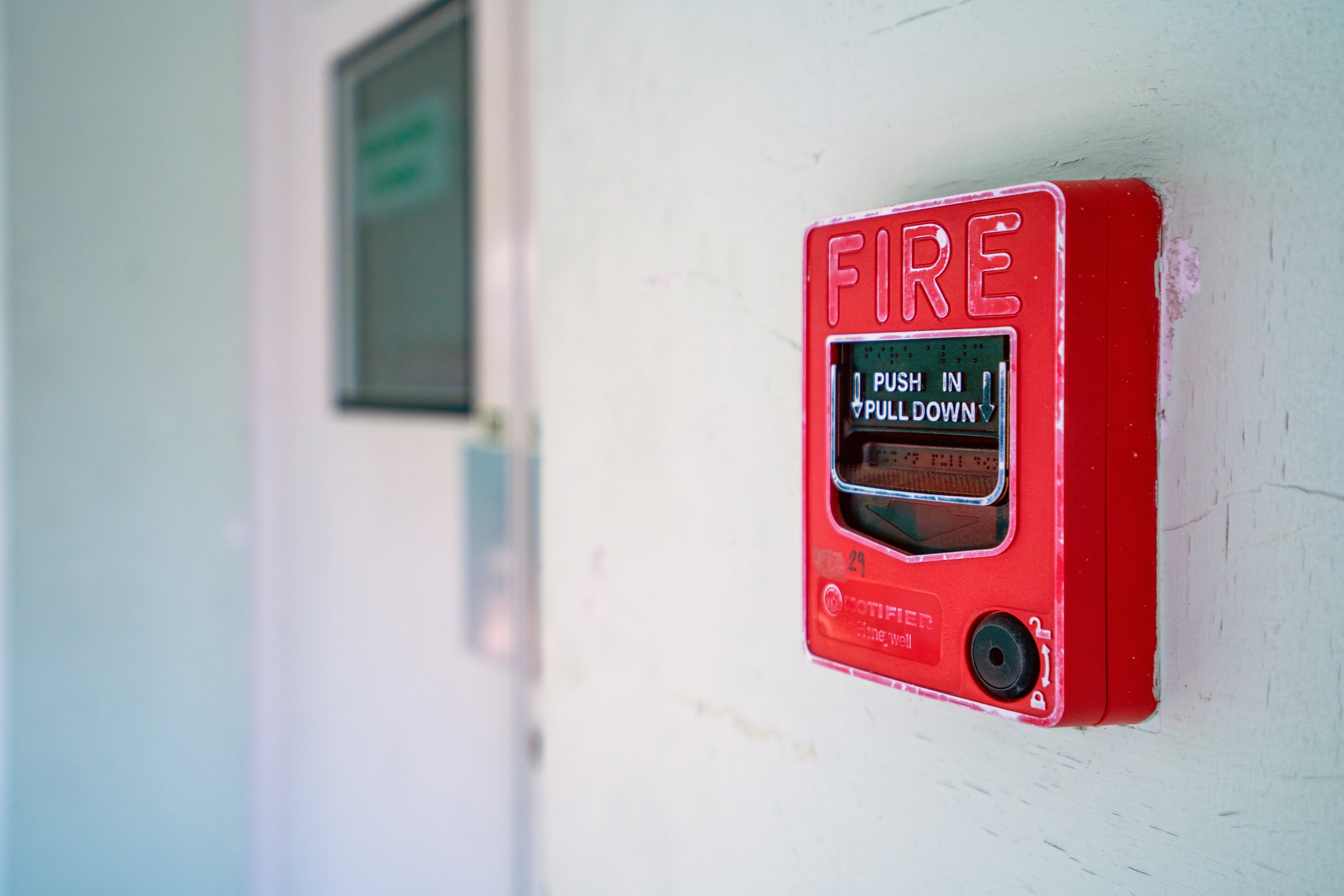 A red device on a white wall.