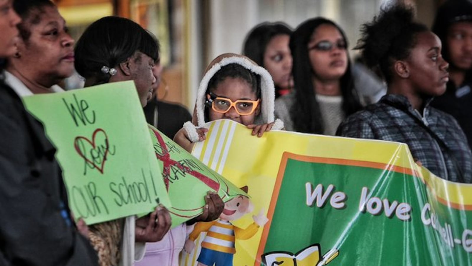 Caldwell-Guthrie Elementary School student Jonisha Simms (center) listens as parents and members of the school's neighborhood advisory council protest in December in front of the Shelby County Schools' administration building over the charter matching process established by the Achievement School District.
