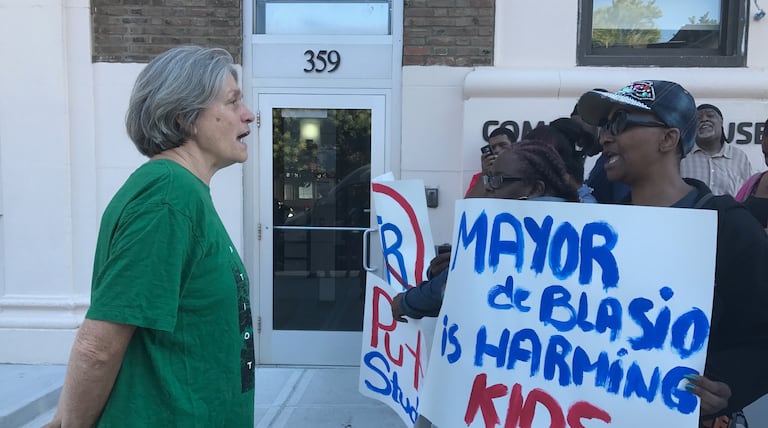 Protesters face off with member of New York City’s Absent Teacher Reserve outside the mayor’s gym