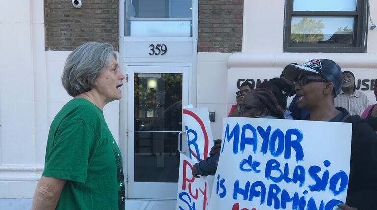 Protesters face off with member of New York City’s Absent Teacher Reserve outside the mayor’s gym