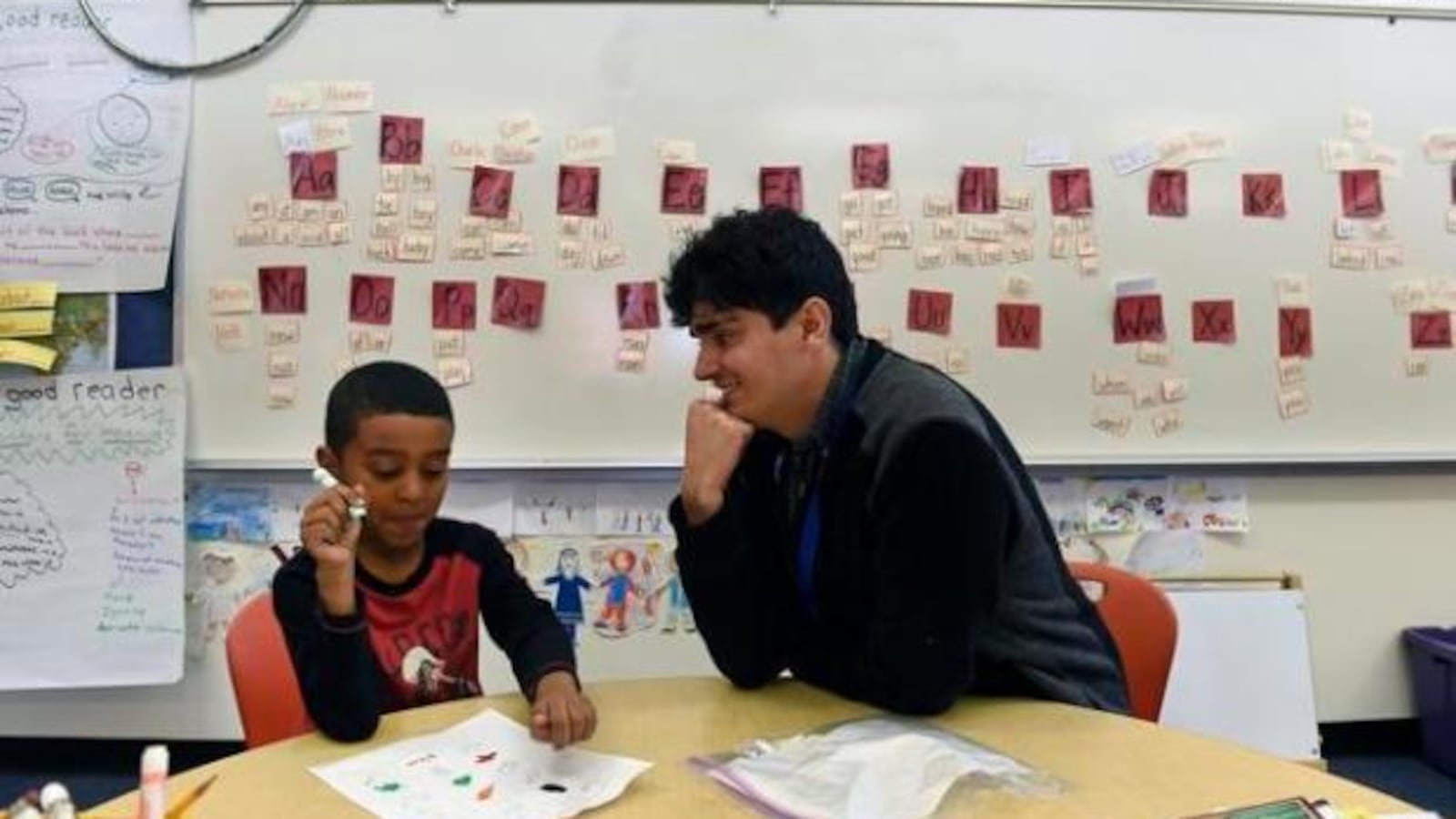 Substitute teacher Steven Mares, right, works with a student at Denver Green School in 2016. (Photo by Helen H. Richardson/The Denver Post)
