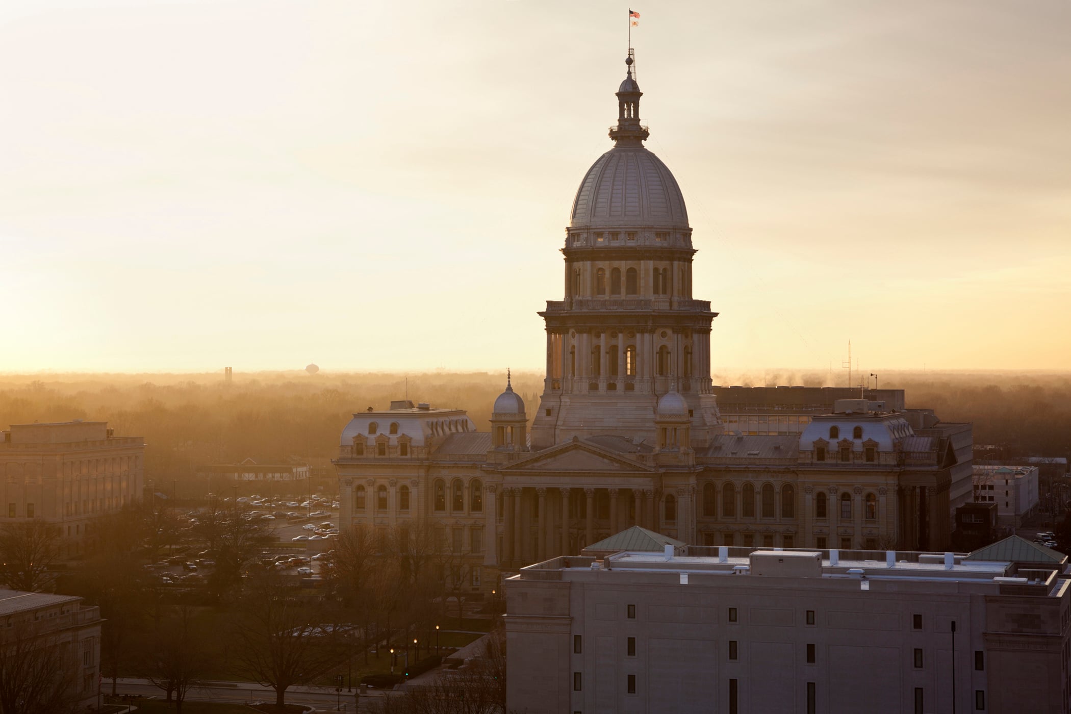 A photograph of the Illinois state Capitol building while the sun illuminates side of the building.