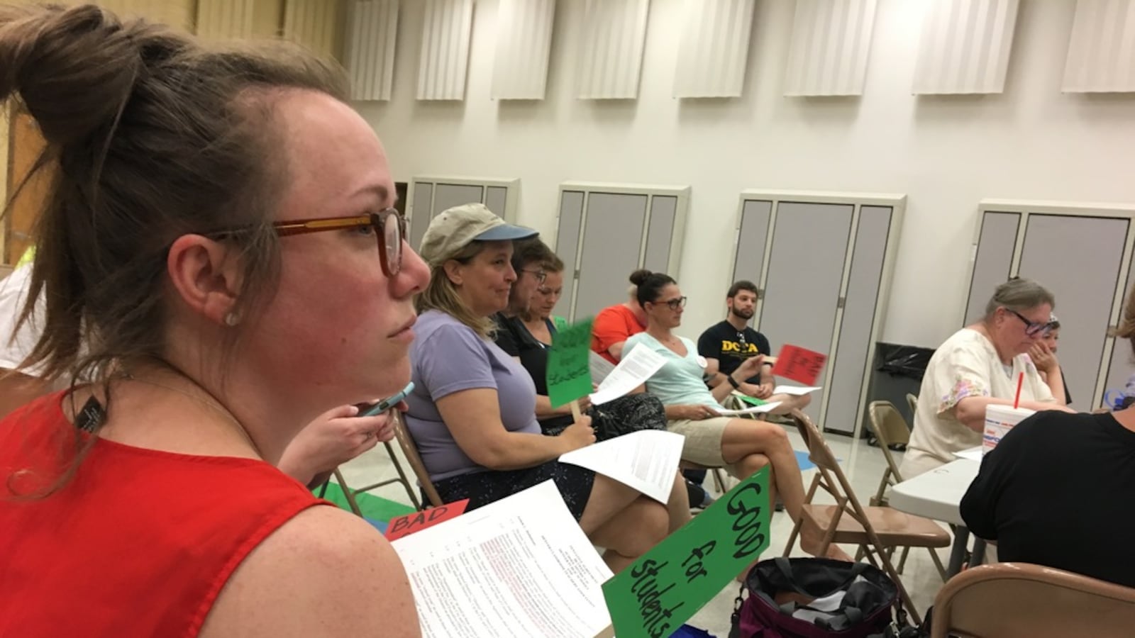 Teachers watch a master contract bargaining session between Denver Public Schools and the Denver teachers union on June 22.