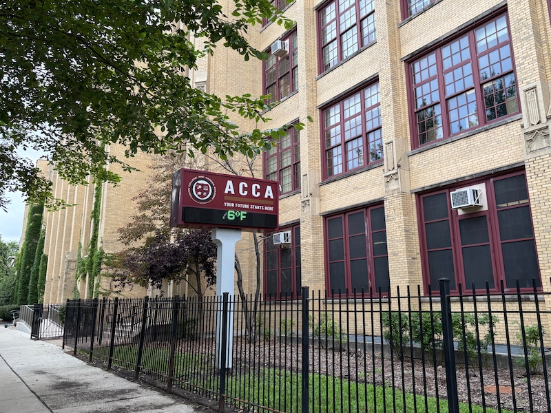 The front entrance of a school building on a cloudy summer day.