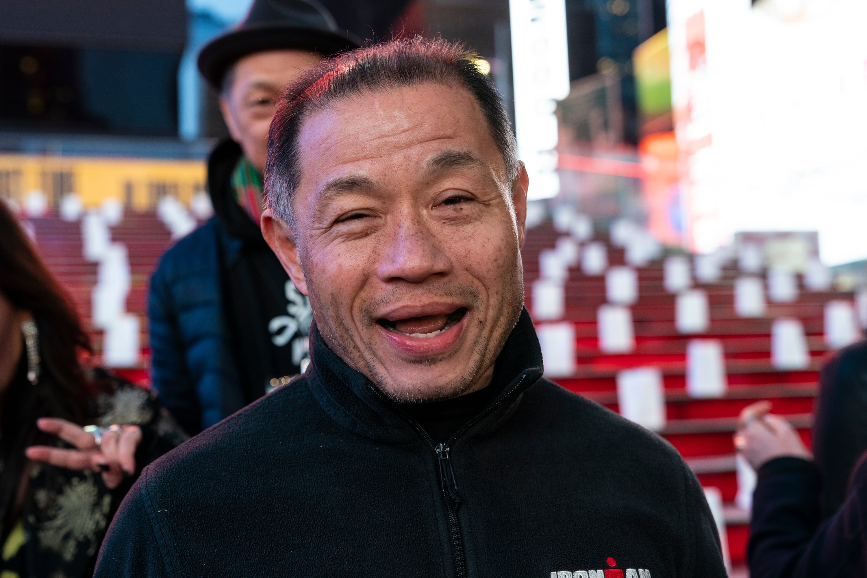 A man with a black turtleneck smiles.