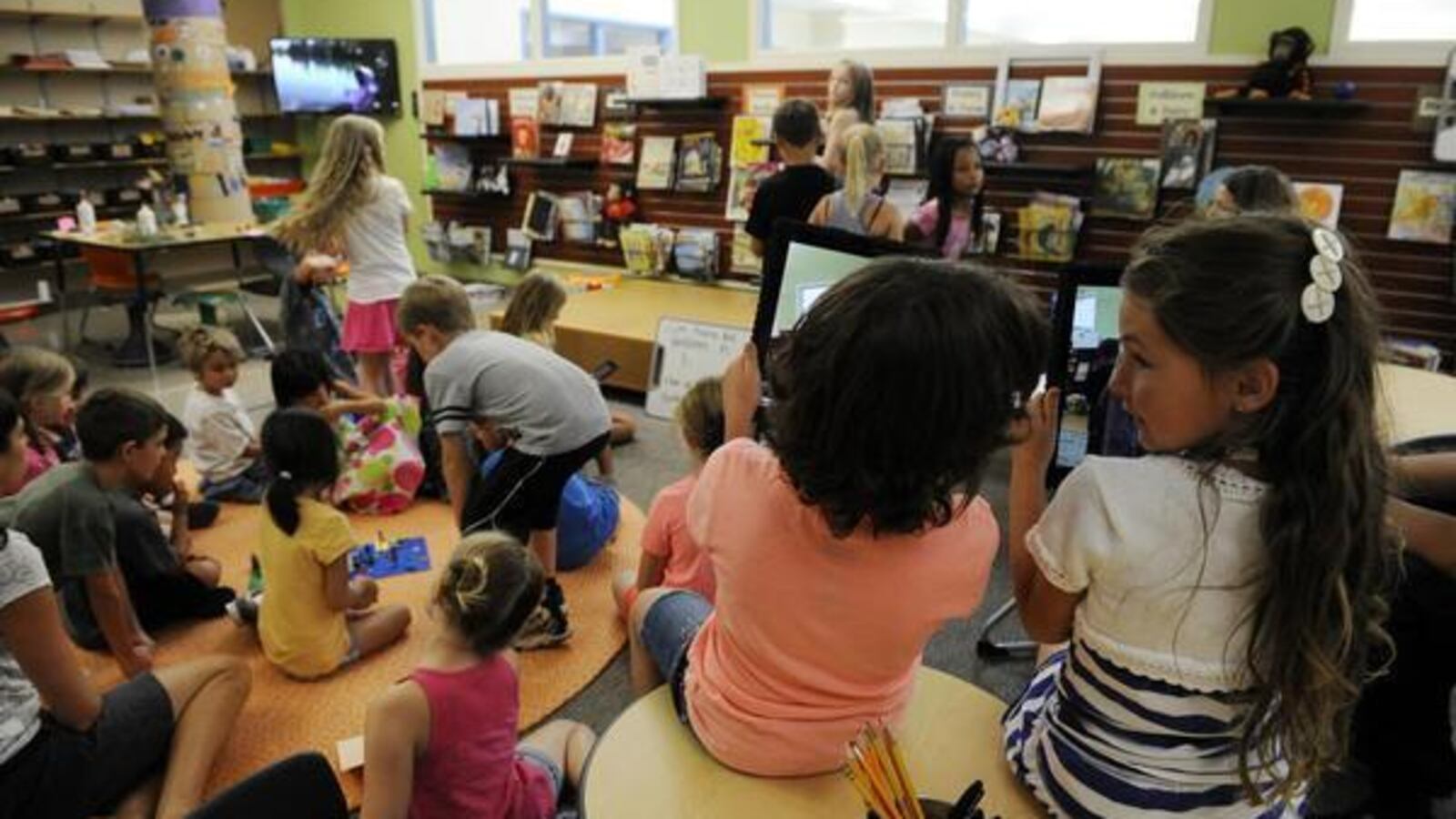 Patyn Hooper, right, and Rowan LaPiano compare their reporting videos during class at Mammoth Heights Elementary School in Parker, Colorado.