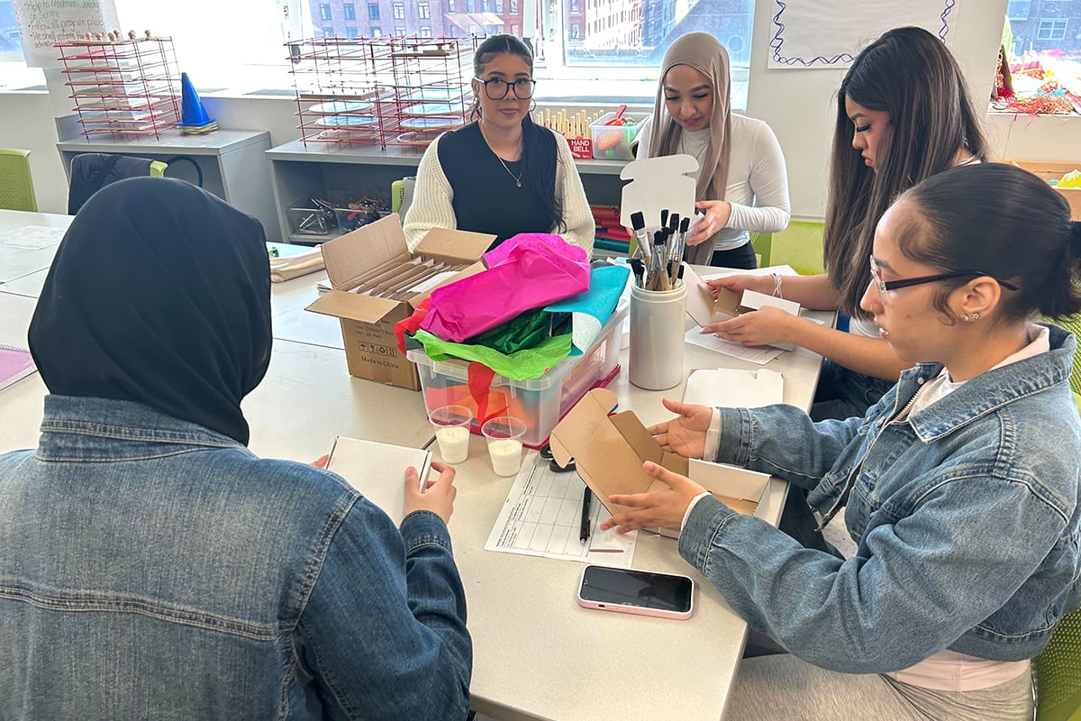 Students work around a table.