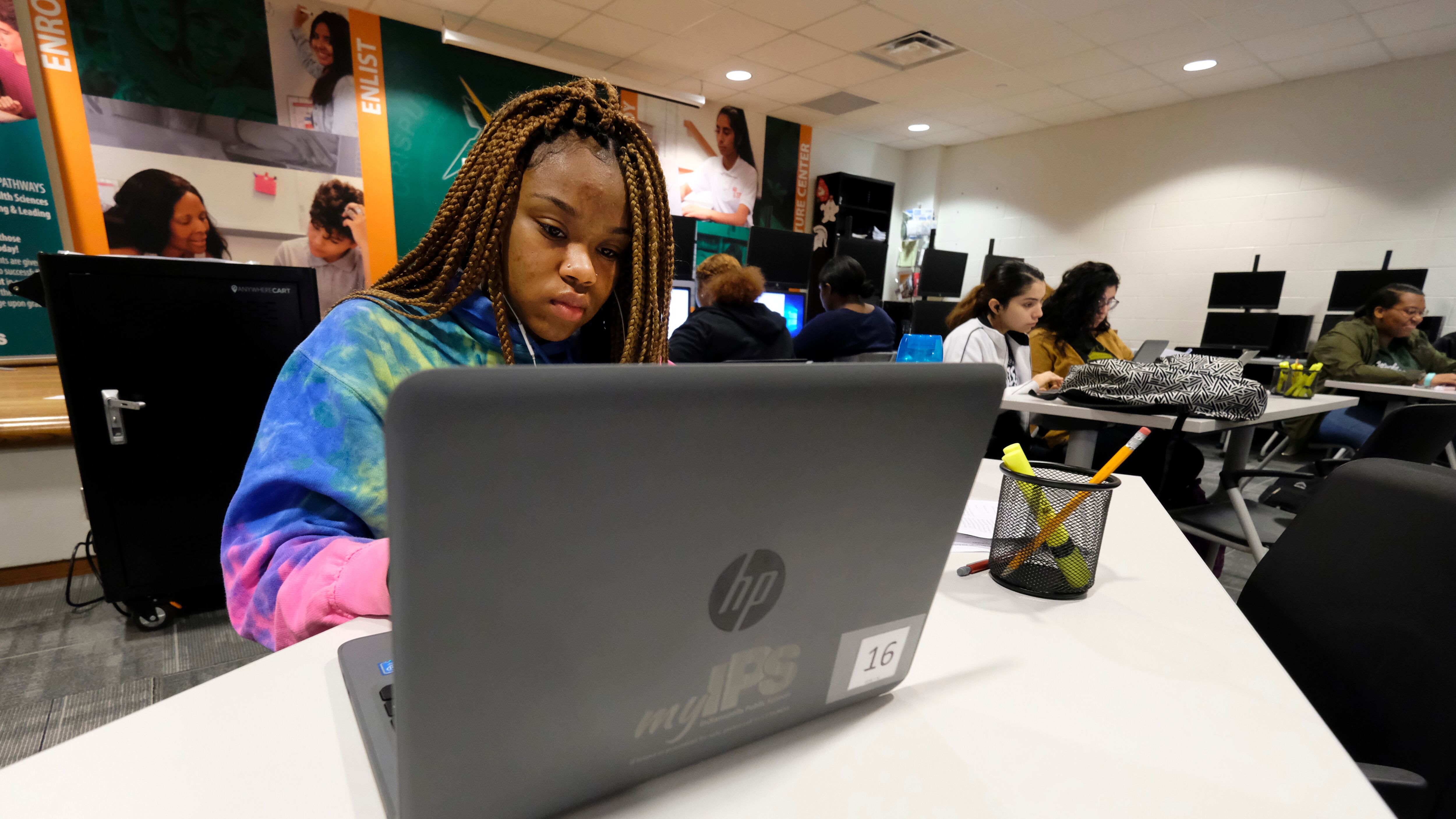 A student works at a laptop computer in a classroom at Crispus Attucks High School, a public school in Indianapolis, Indiana.