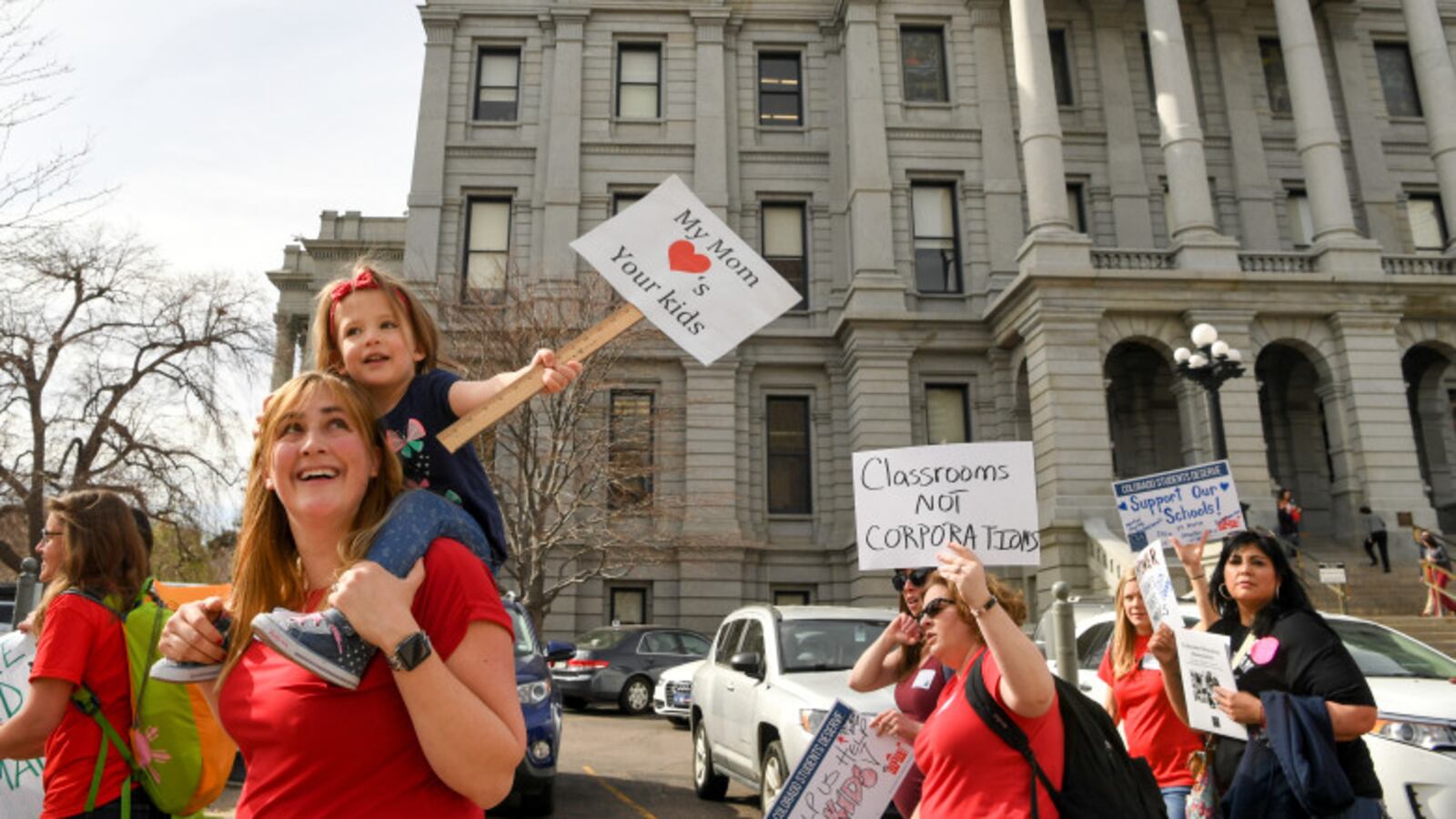 Teacher Christina Hafler and her two-year-old daughter Emma join hundreds of other educators at a rally outside the State Capitol to call for increased eduction funding on April 16, 2018 in Denver, Colorado. (Photo by RJ Sangosti/The Denver Post)