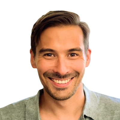 Headshot of a man with dark hair. He wears a sage shirt.