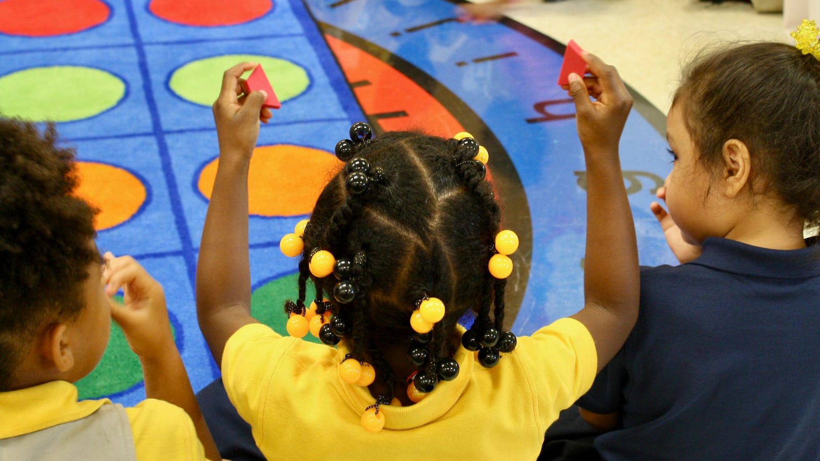 The students learn to identify shapes and compare and contrast them by size, number of sides and color.