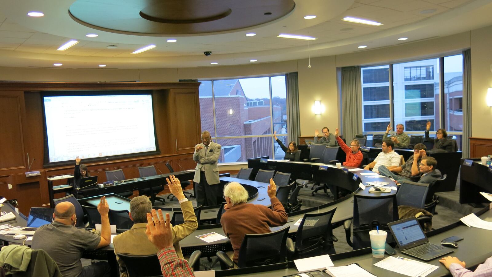 University of Memphis Faculty Senate President Reginald Green counts senators' votes in support of drafting a resolution raising concerns about the school's proposed partnership with Relay Graduate School during Tuesday's meeting.