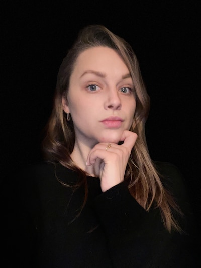 Headshot of a woman wearing black looking directly at the camera.