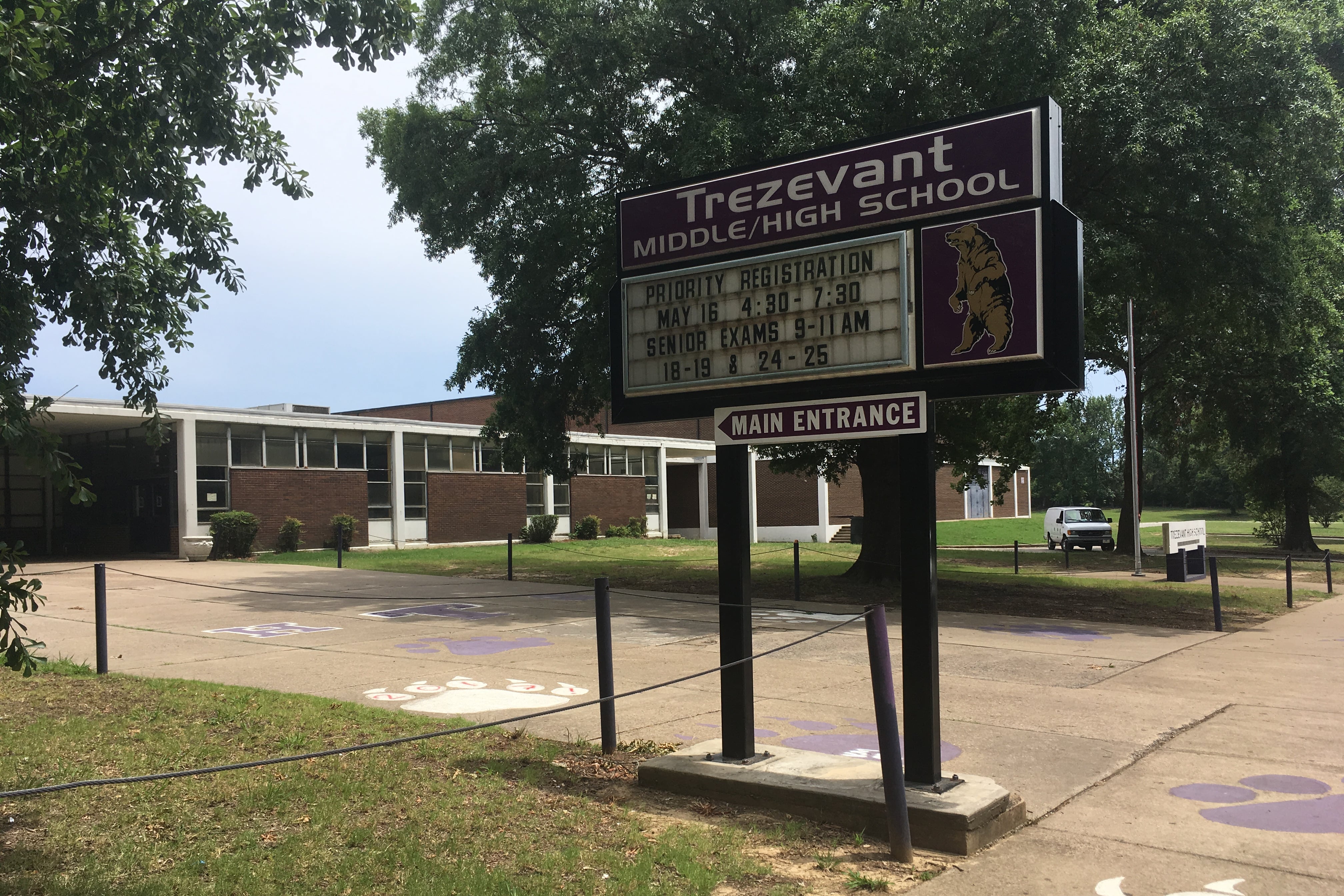 An exterior of a school building, identified on a sign as Trezevant High School.