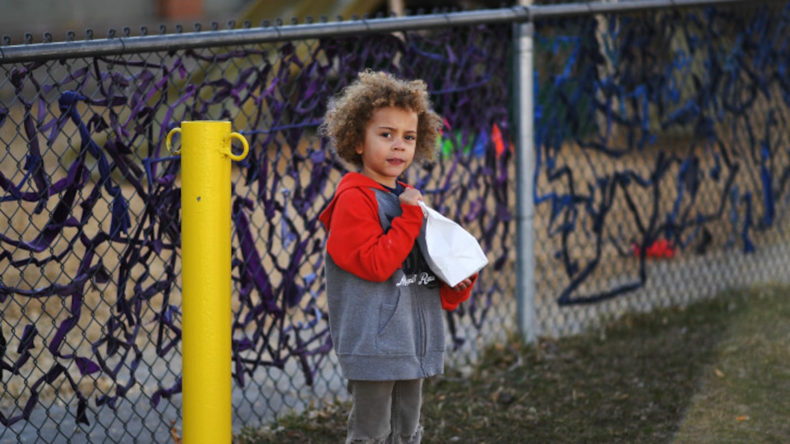 Four-year-old Jaxson Rubal holds a free sack breakfast given to him outside Cowell Elementary on March 16, 2020 in Denver, Colorado.