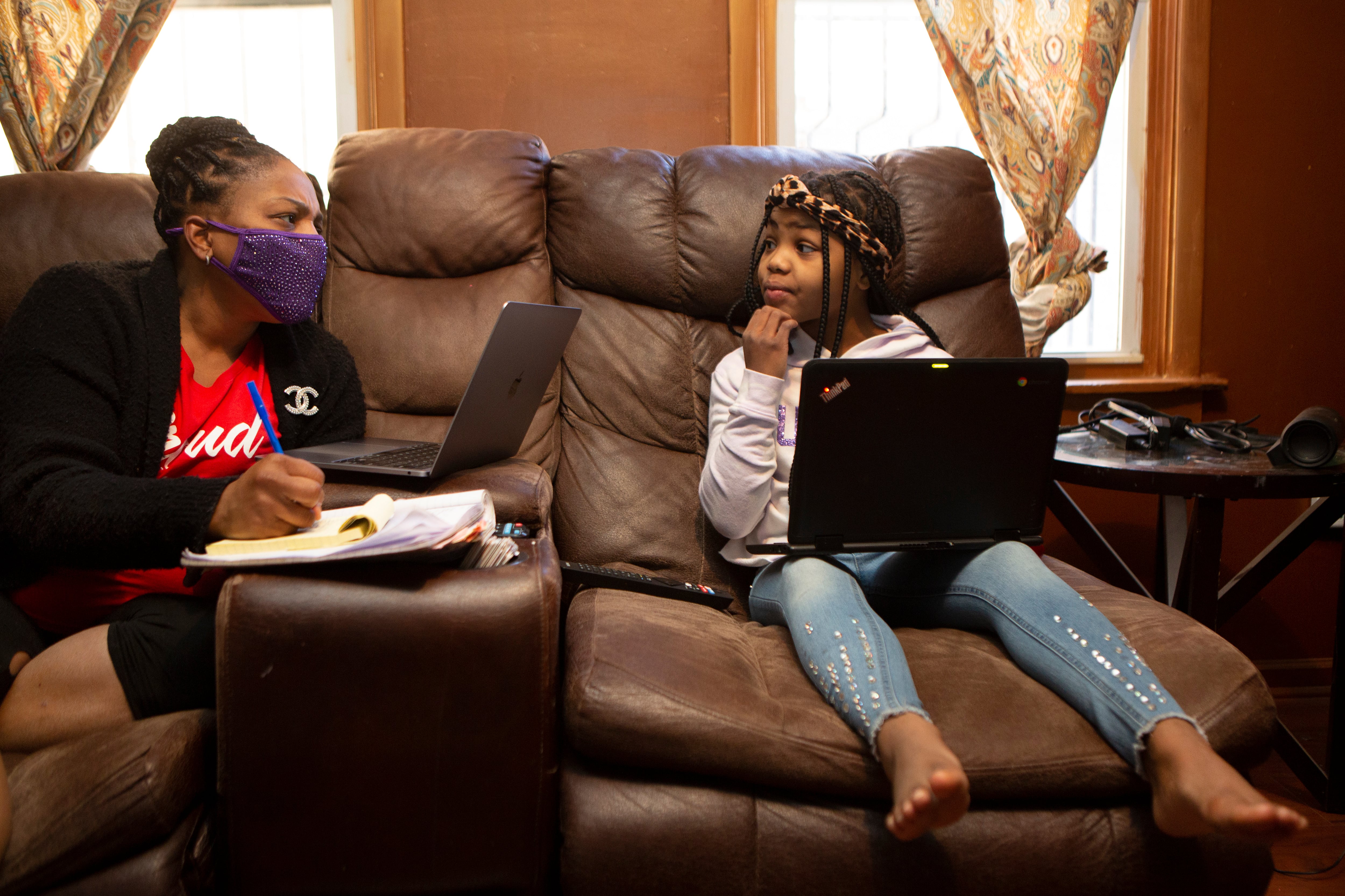 Joicki Floyd starts her day for Weequahic High School remotely and also chats with her daughter Donnell as she also prepares for her own remote learning from their home in Newark on Wednesday morning, Mar. 3, 2021.