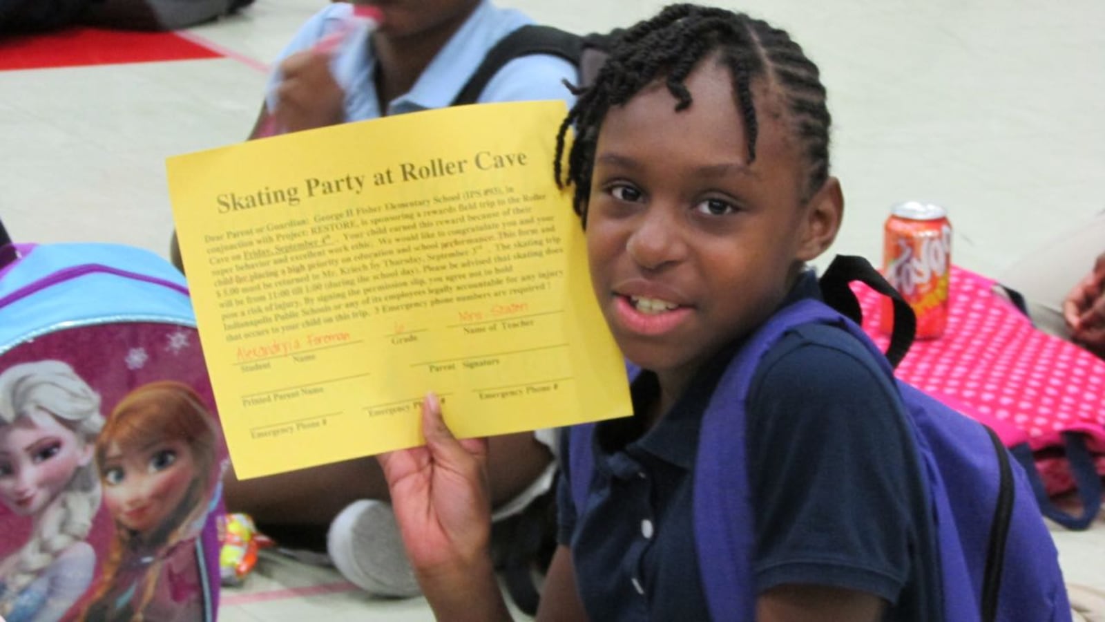 A student with a "golden ticket" for a skating party as a reward for good work at School 93. As a Project Restore school, it is an example of an IPS school that operates with a degree of independence.