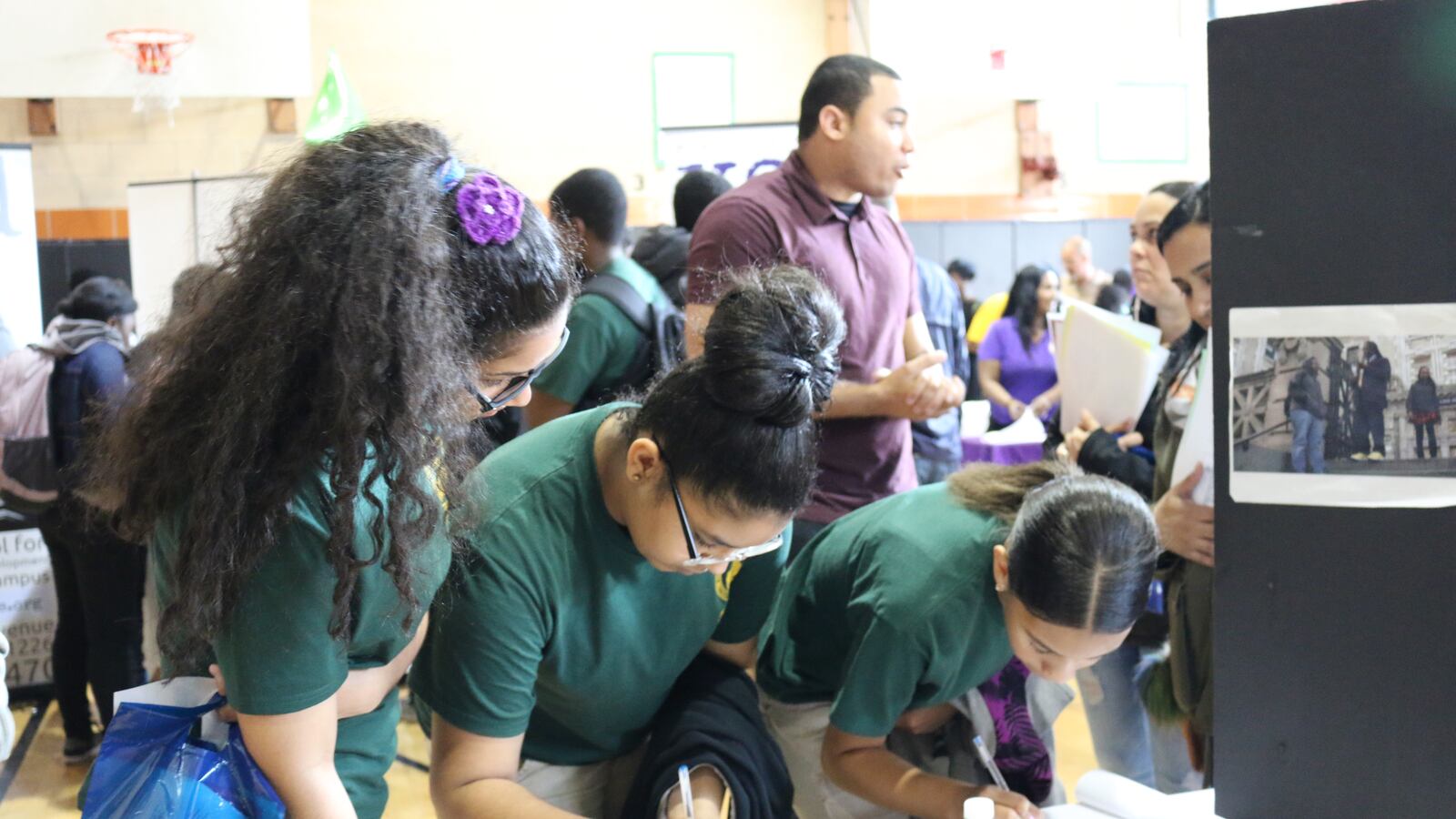 Middle school students write their names down at a high school fair in Brooklyn in 2016.