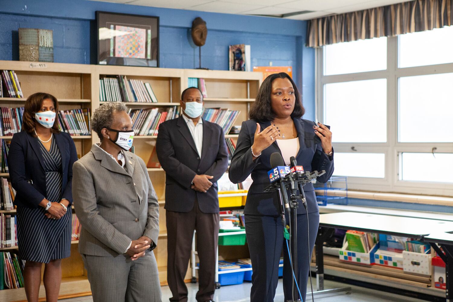 School chief Janice Jackson speaking into microphones at a press conference.