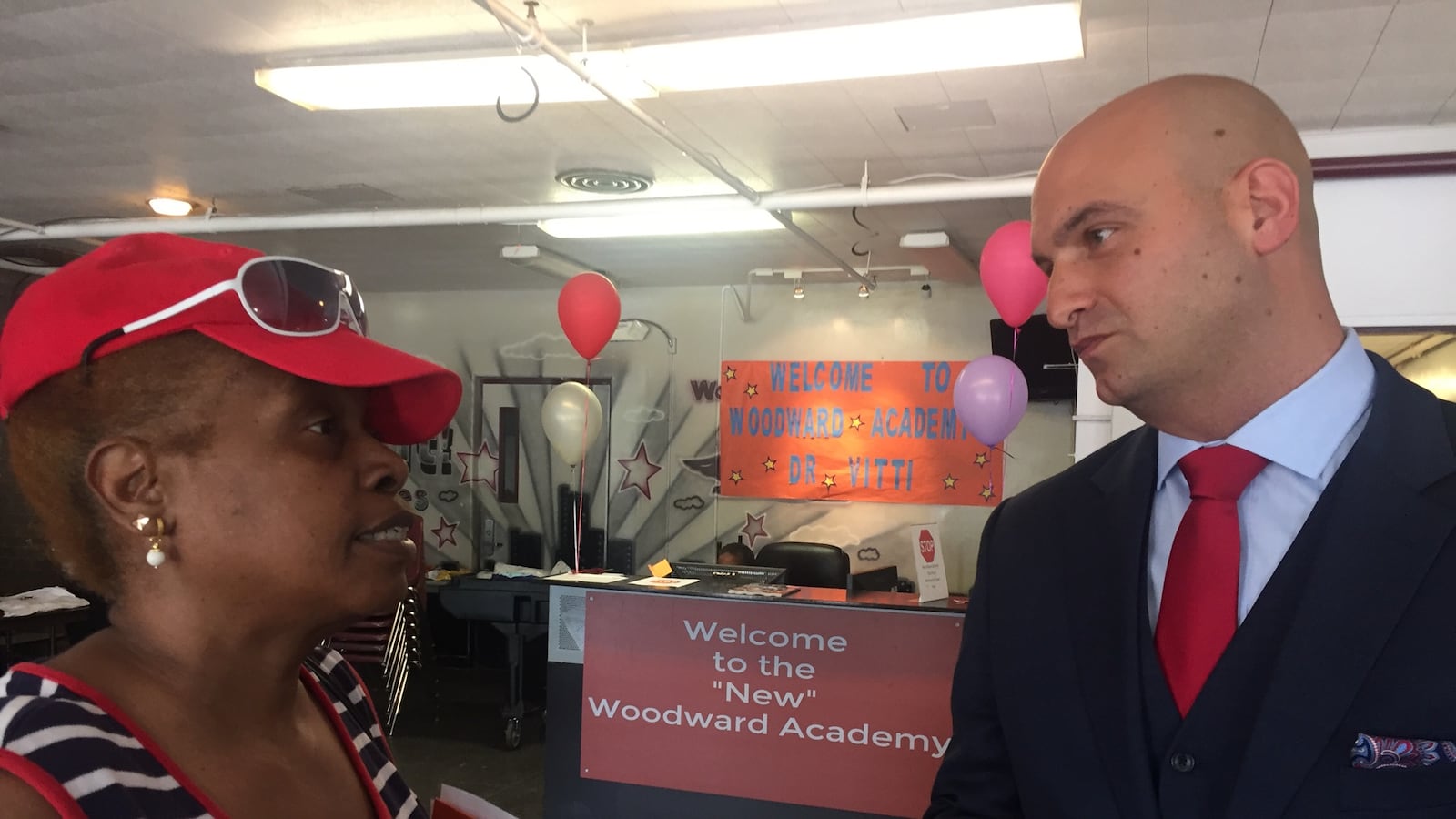 Detroit schools Superintendent Nikolai Vitti speaks with Detroiter Judy Lewis. whose granddaughter Kymora now attends the Woodward Academy.