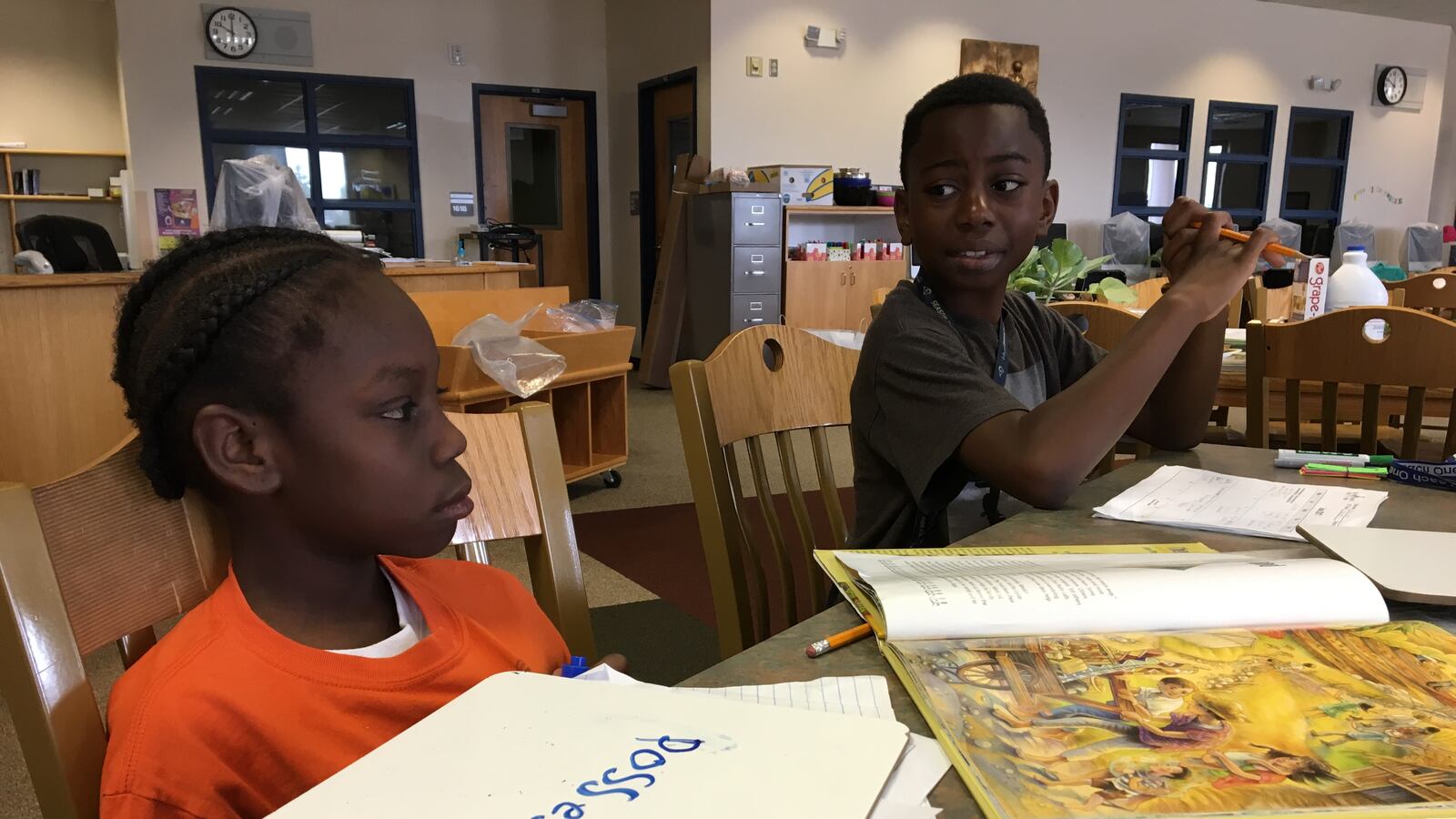 Greenwood students Ja'zione and Arinze practice spelling the word "possessions" at the Each One Teach One literacy program. (Photo by Marissa Page)